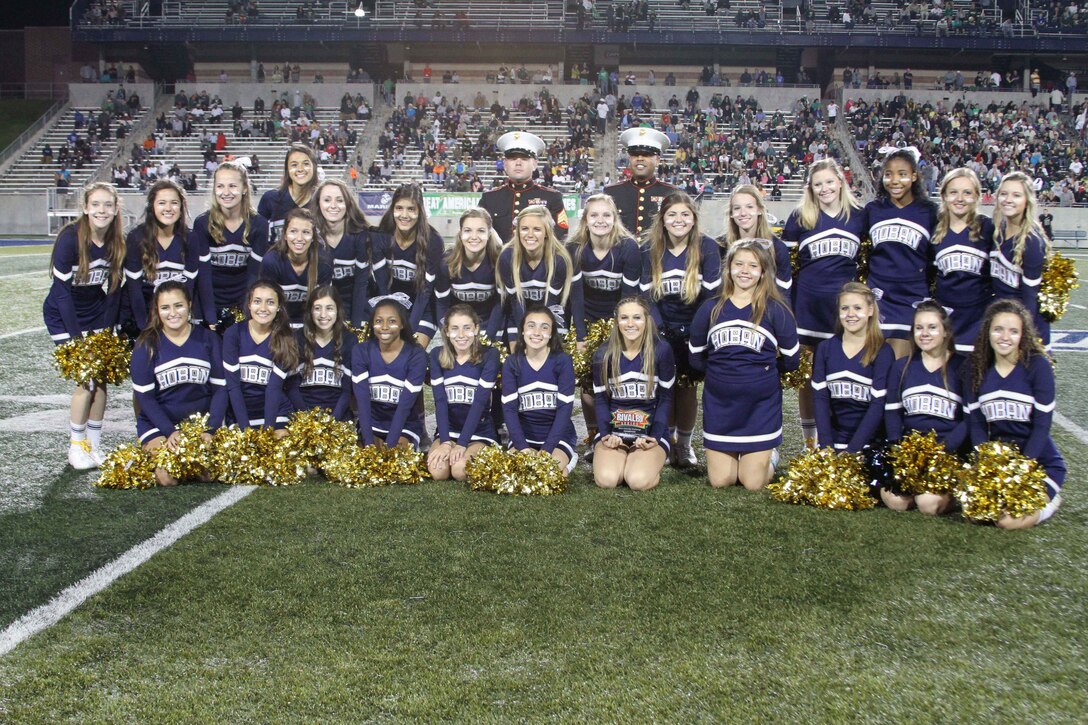U.S. Marine Corps Sgts. David Belcher and Ryan Johnson, canvassing recruiters with Recruiting Sub-Station Akron, present the cheerleaders of Archbishop Hoban the Pull-up Challenge Spirit Award during the third quarter of their football game against St. Vincent St. Mary, at University of Akron’s InfoCision Stadium, Sept. 26, 2014. The Archbishop Hoban Knights’ spirit was not enough as they lost the game on the field 33-27 in triple overtime. (U.S. Marine Corps photo by Sgt. T.M. Stewman/Released)