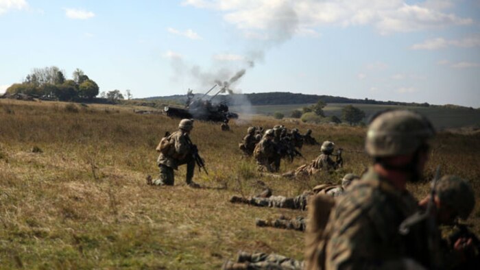 Marines with Black Sea Rotational Force 14 look on as Romanian armored vehicles engage targets downrange during a live-fire range at Cincu-14 September 25. The exercise was designed to promote interoperability between both countries with military-to-military training, live-fire ranges, fire support coordination training and sharing tactics, techniques and procedures.