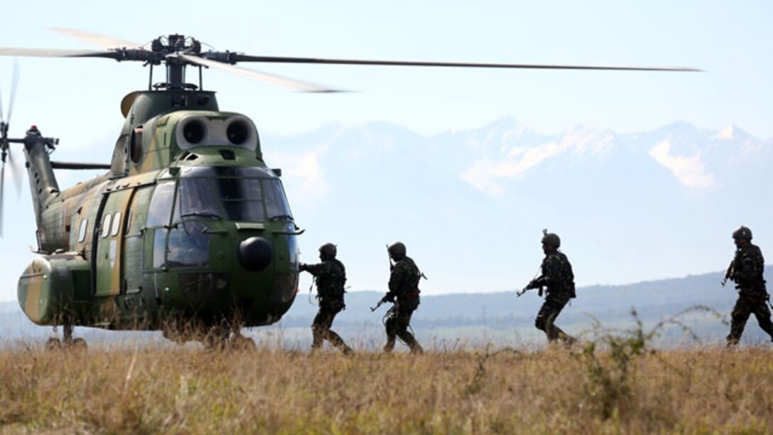 Romanian forces board a helicopter as part of the CINCU-14 exercise designed to promote interoperability with U.S. forces. This type of cooperation amplifies the ability to respond to current and future threats in the region.