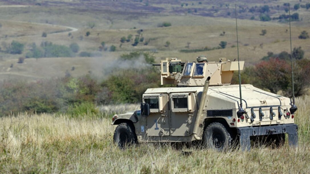 A Marine with Black Sea Rotational Force 14 engages targets with a mounted .50-caliber machine gun during a live-fire range at Cincu-14 September 25. The exercise was designed to promote interoperability between both countries with military-to-military training, live-fire ranges, fire support coordination training and sharing tactics, techniques and procedures.