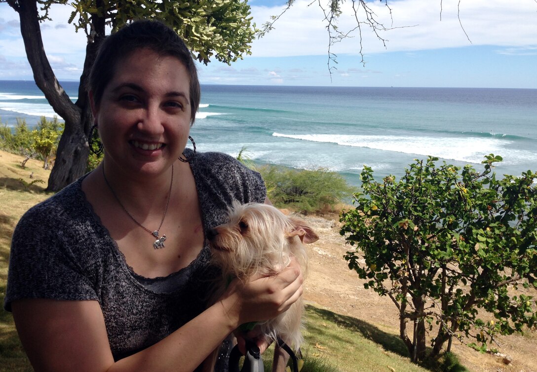 Staff Sgt. Amanda Dick enjoys the Pacific Ocean with her dog, Captain Jack Sparrow, four months after her last chemotherapy treatment, Sept. 13, 2014, at Diamond Head Lookout, Hawaii. She is now one of the estimated 2.8 million breast cancer survivors in the U.S. (Courtesy photo)