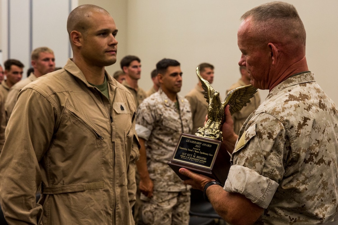 U.S. Marine Maj. Gen. Lawrence D. Nicholson awards the Navy and Marine Corps Association Leadership Award to Sgt. Guy Higgins aboard Camp Pendleton, Calif., Sept. 26, 2014. Higgins, 27, from Murrieta, Calif., is a sniper with Bravo Company, 1st Reconnaissance Battalion. Nicholson is the commanding general of 1st Marine Division. (U.S. Marine Corps photo by Cpl. Anna Albrecht/Released)