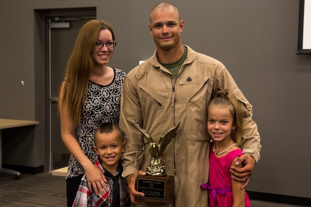 U.S. Marine Sgt. Guy Higgins stands with his family after receiving the Navy and Marine Corps Association Leadership Award aboard Camp Pendleton, Calif., Sept. 26, 2014. Higgins, 27, from Murrieta, Calif., is a sniper with Bravo Company, 1st Reconnaissance Battalion. (U.S. Marine Corps photo by Cpl. Anna Albrecht/Released)