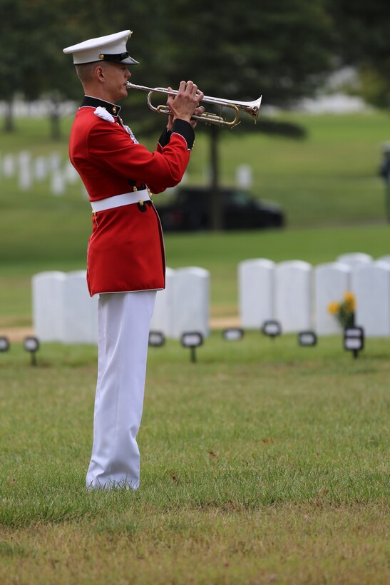 On Sept. 30, 2014, Marines from Marine Barracks Washington participated in the funeral for Major Kurt Chew-Een Lee, USMC (ret.) at Arlington National Cemetery. Major Lee was the first Asian-American Marine Corps officer and a legendary hero at the Battle of Chosin Reservoir during the Korean War. His exploits later became the subject of the Smithsonian Channel's documentary "Uncommon Courage: Breakout at Chosin." Pictured, Master Sgt. Scott Gearhart sounds "Taps."(U.S. Marine Corps photo by Gunnery Sgt. Amanda Simmons/released)