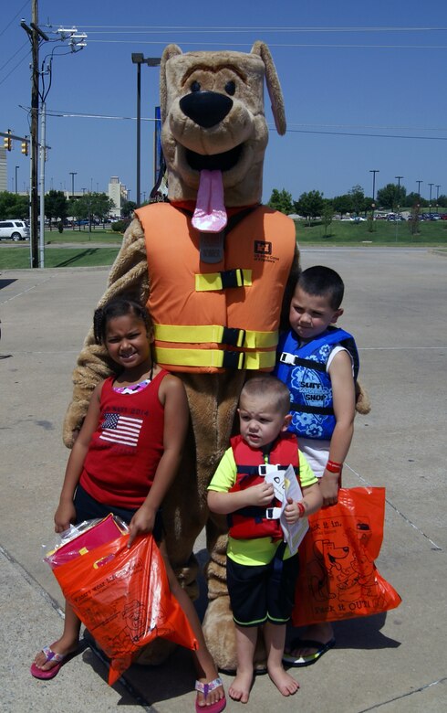 Bobber the Water Safety Dog and some of his pals at the Water Safety Day event July 13. The children received free life jackets from Safe Kids and other water safety-related goodies.                     