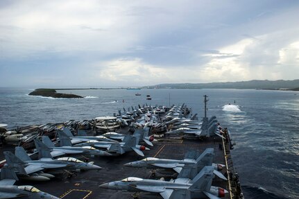 APRA HARBOR, Guam (Oct. 2, 2014) - The aircraft carrier USS George Washington (CVN 73) arrives in Guam for a port visit, which comes after recently taking part in Valiant Shield, a joint U.S. exercise that brought together more than 18,000 service members, 200 aircraft and 19 surface vessels for integrated training in and around Guam. George Washington and its embarked air wing, Carrier Air Wing (CVW) 5, provide a combat-ready force that protects and defends the collective maritime interests of the U.S. and its allies and partners in the Indo-Asia-Pacific.  141002-N-XK455-014
