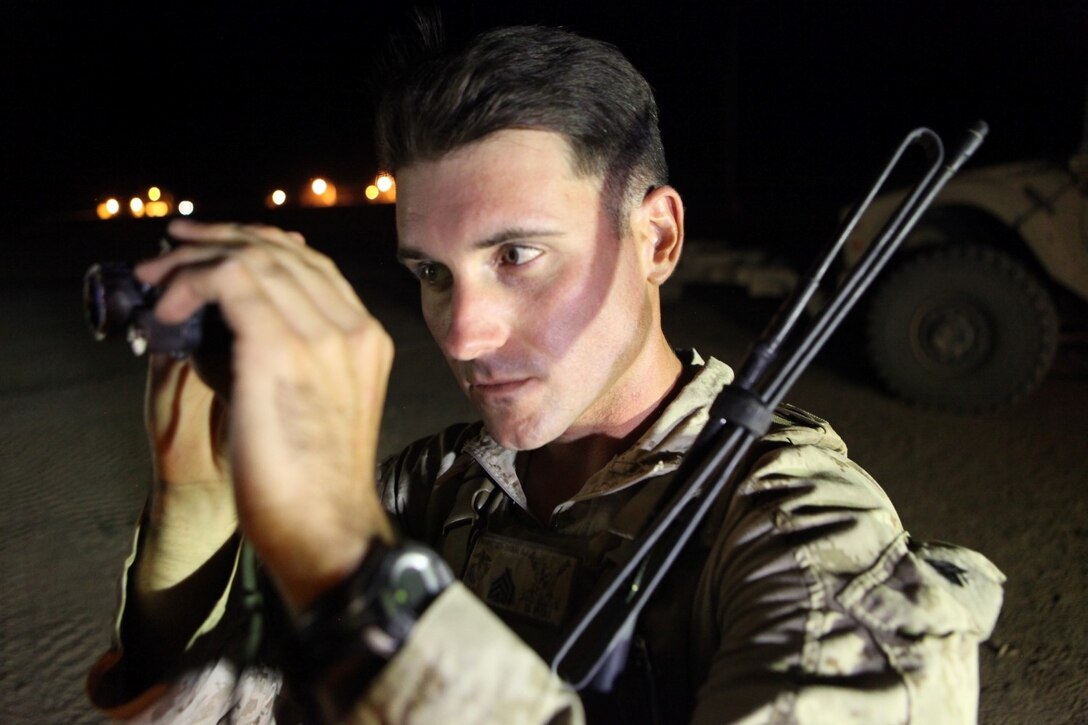 Sergeant Dominic Sharpsteensurina, a native of Apple Valley, California, and an assault section leader with Weapons Platoon, Charley Company, 1st Battalion, 7th Marine Regiment, inspects his PVS-14 night vision system aboard Camp Dwyer, Helmand province, Afghanistan, Sept. 21, 2014. During his current deployment in Afghanistan, Sharpsteensurina was meritoriously promoted to the rank of sergeant. He is glad to be able to take part in Operation Enduring Freedom with his fellow infantrymen and become someone they can look up to. (U.S. Marine Corps photo by Cpl. Cody Haas/ Released)