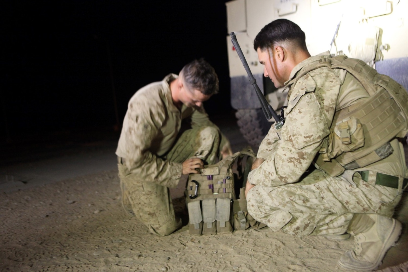 Sergeant Dominic Sharpsteensurina, right, a native of Apple Valley, California, and an assault section leader with Weapons Platoon, Charley Company, 1st Battalion, 7th Marine Regiment, inspects another Marine’s gear aboard Camp Dwyer, Helmand province, Afghanistan, Sept. 21, 2014. During his current deployment in Afghanistan, Sharpsteensurina was meritoriously promoted to the rank of sergeant. He is glad to be able to take part in Operation Enduring Freedom with his fellow infantrymen and become someone they can look up to. (U.S. Marine Corps photo by Cpl. Cody Haas/ Released)