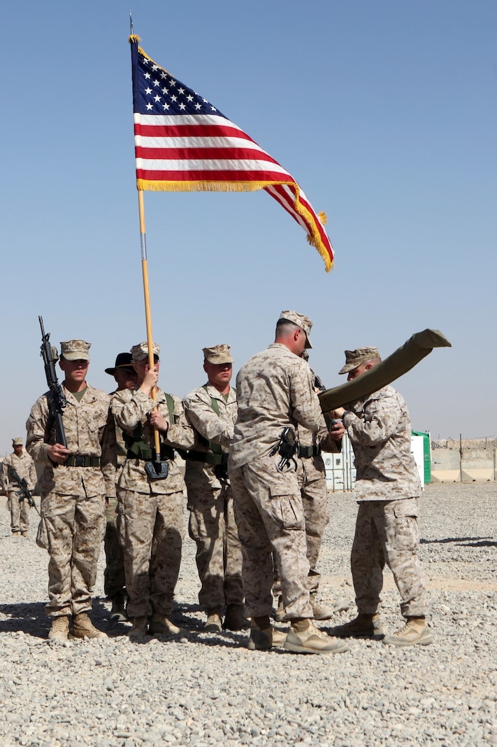 Lieutenant Col. Seth Yost, right, commanding officer, 1st Battalion, 7th Marines, and 1st Sgt. Jordan Freeland, center, Charley Company first sergeant, case the battalion’s battle colors during a transfer of authority ceremony aboard Tactical Base Dwyer, Afghanistan, Oct. 1, 2014. The ceremony signified the battalion’s transfer of authority of the base and their area of responsibility to 3rd Squadron, 3rd Cavalry Regiment, a U.S. Army command based out of Fort Hood, Texas. The ceremony also meant the end of combat operations for 7th Marines – a regiment which has been actively supporting Operation Enduring Freedom for several years.