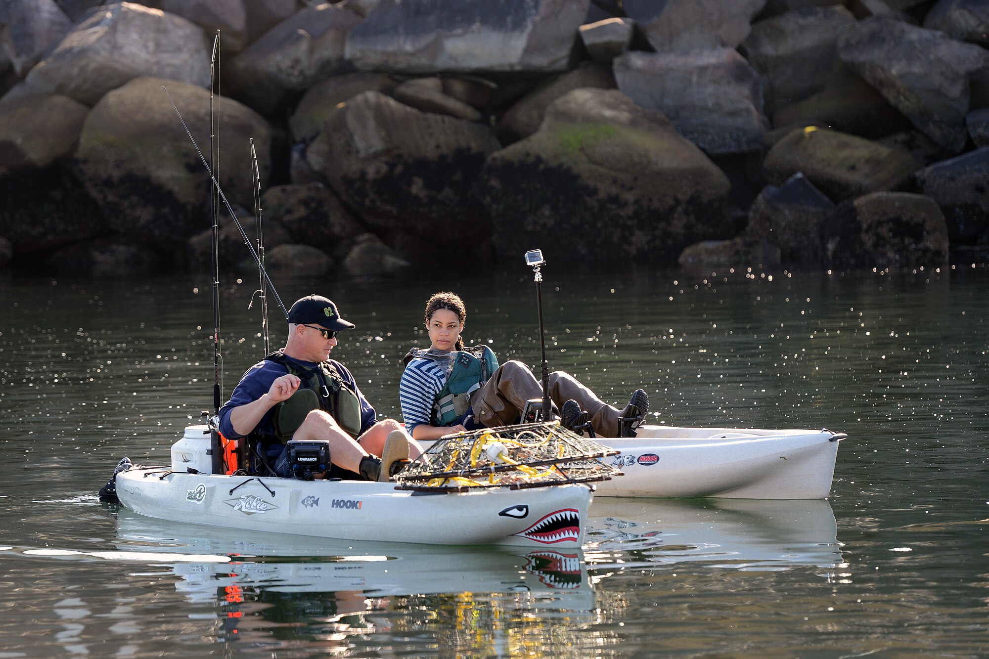 Chief Master Sgt. Gordon Drake, 62nd Airlift Wing command chief, shows Senior Airman Gabrielle Hall, 627th Security Forces patrolwoman, how to maneuver a kayak on the water Oct. 2, 2014 at the southern Puget Sound, Wash. Hall spent the day of mentorship with Drake learning how to fish and catch crab from a kayak. (U.S. Air Force photo/Airman 1st Class Jacob Jimenez)