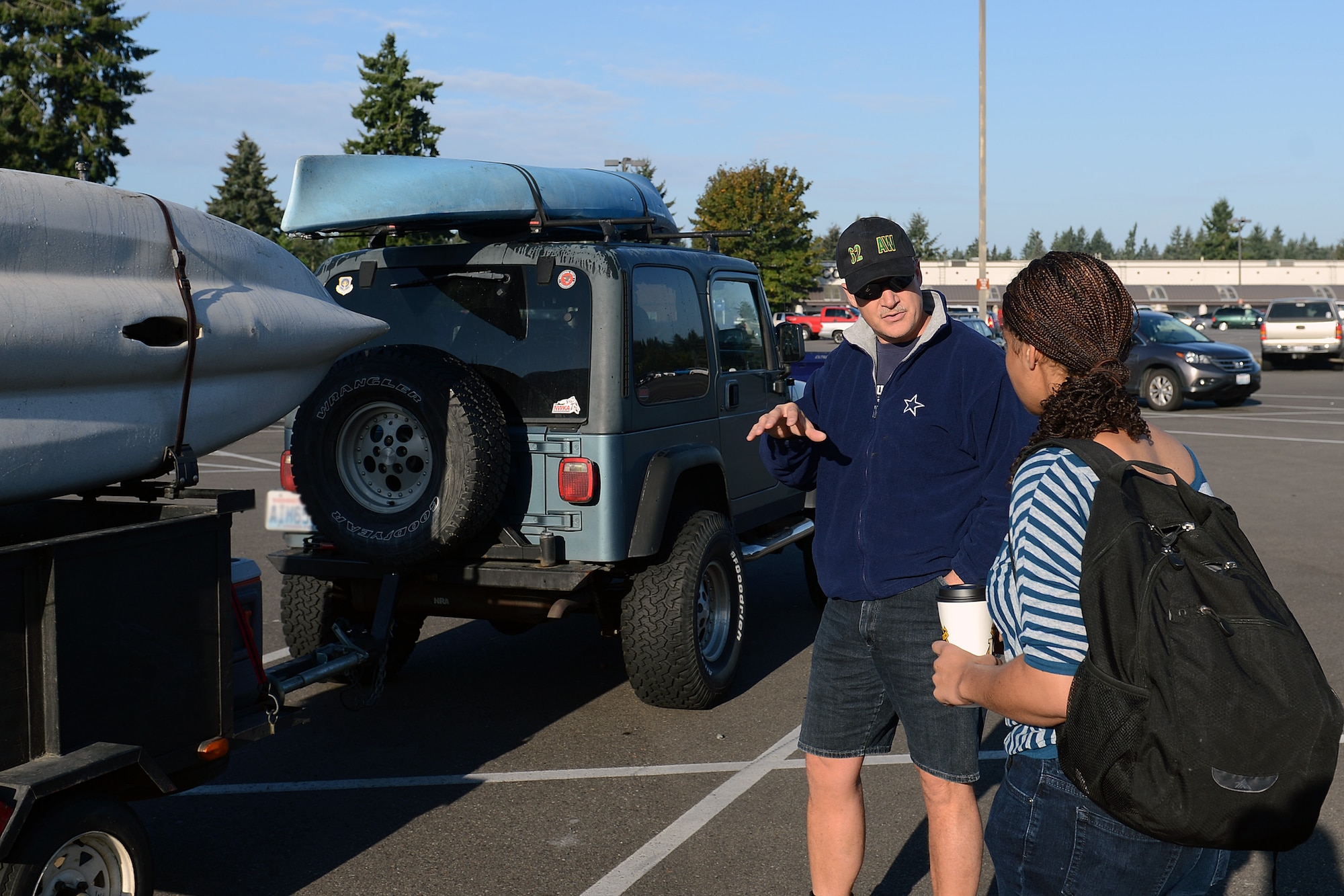 Chief Master Sgt. Gordon Drake, 62nd Airlift Wing command chief, meets Senior Airman Gabrielle Hall, 627th Security Forces Squadron patrolwoman, by the McChord Field Commissary to go fishing Oct. 2, 2014, at Joint Base Lewis-McChord, Wash. Hall won the fishing trip last Wingman Day in a “How Well Do You Know Your Airman” game. (U.S. Air Force photo/Airman 1st Class Jacob Jimenez)