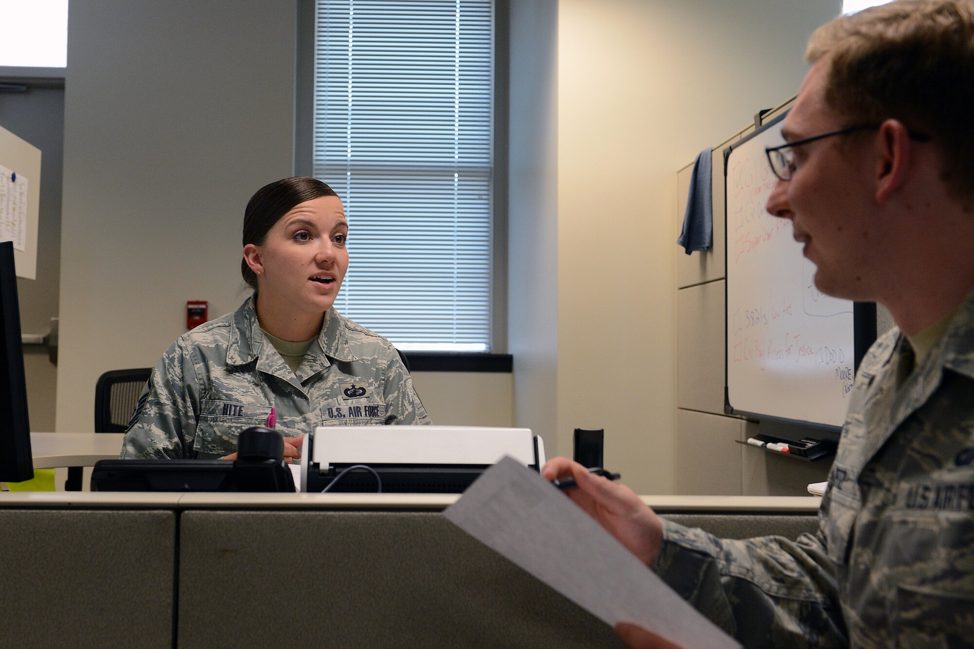 Master Sgt. Brandy Hite, 62nd Comptroller Squadron financial management analysis flight chief, and Airman 1st Class Zachary Betz, 62nd CPTS budget analysis, examine budget documents prior to end-of-year closeout Sept. 30, 2014, at Joint Base Lewis-McChord, Wash. The Air Force began its new 2015 fiscal year Oct. 1st. (U.S. Air Force photo/Airman 1st Class Jacob Jimenez)