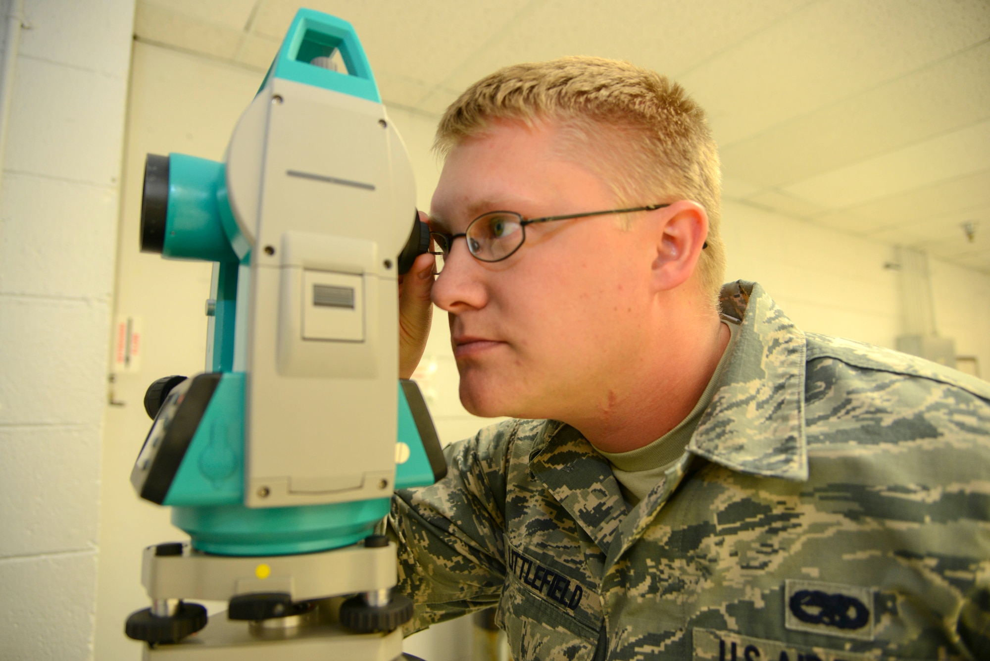 Senior Airman Johnathan Littlefield, 60th Maintenance Squadron Test, Measurement and Diagnostics Equipment Flight, looks through a Theodolite to test the precision instrument’s accuracy in measuring angles and distance Sept. 30 on Travis Air Force Base. (U.S. Air Force photo/Senior Airman Madelyn Brown).