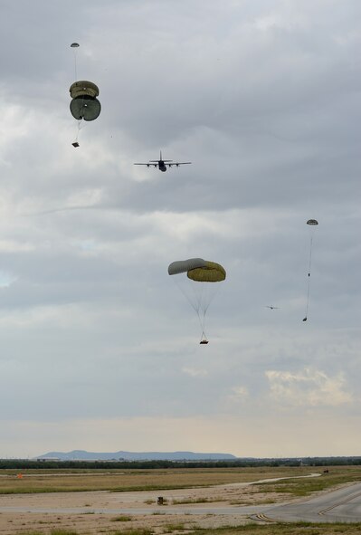 Airdrops from two U.S. Air Force C-130Js Super Hercules assigned to the 317th Airlift Group, fall to the ground Sept. 26, 2014, at Dyess Air Force Base, Texas. After participating in an in-house airdrop competition, three formations of C-130Js dispersed to Pope AFB, N.C., Scott AFB, Ill., and Little Rock AFB, Ark., for separate weekend training events. (U.S. Air Force photo by Senior Airman Peter Thompson/Released)