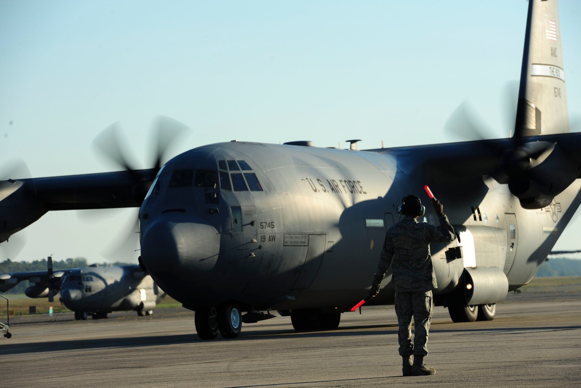 A 19th Aircraft Maintenance Squadron crew chief marshals a C-130J Sept. 29, 2014, at Little Rock Air Force Base, Ark. Aircraft marshalling provides hand signals to personnel taxiing or operating aircraft on the ground. (U.S. Air Force photo by Senior Airman Kaylee Clark)