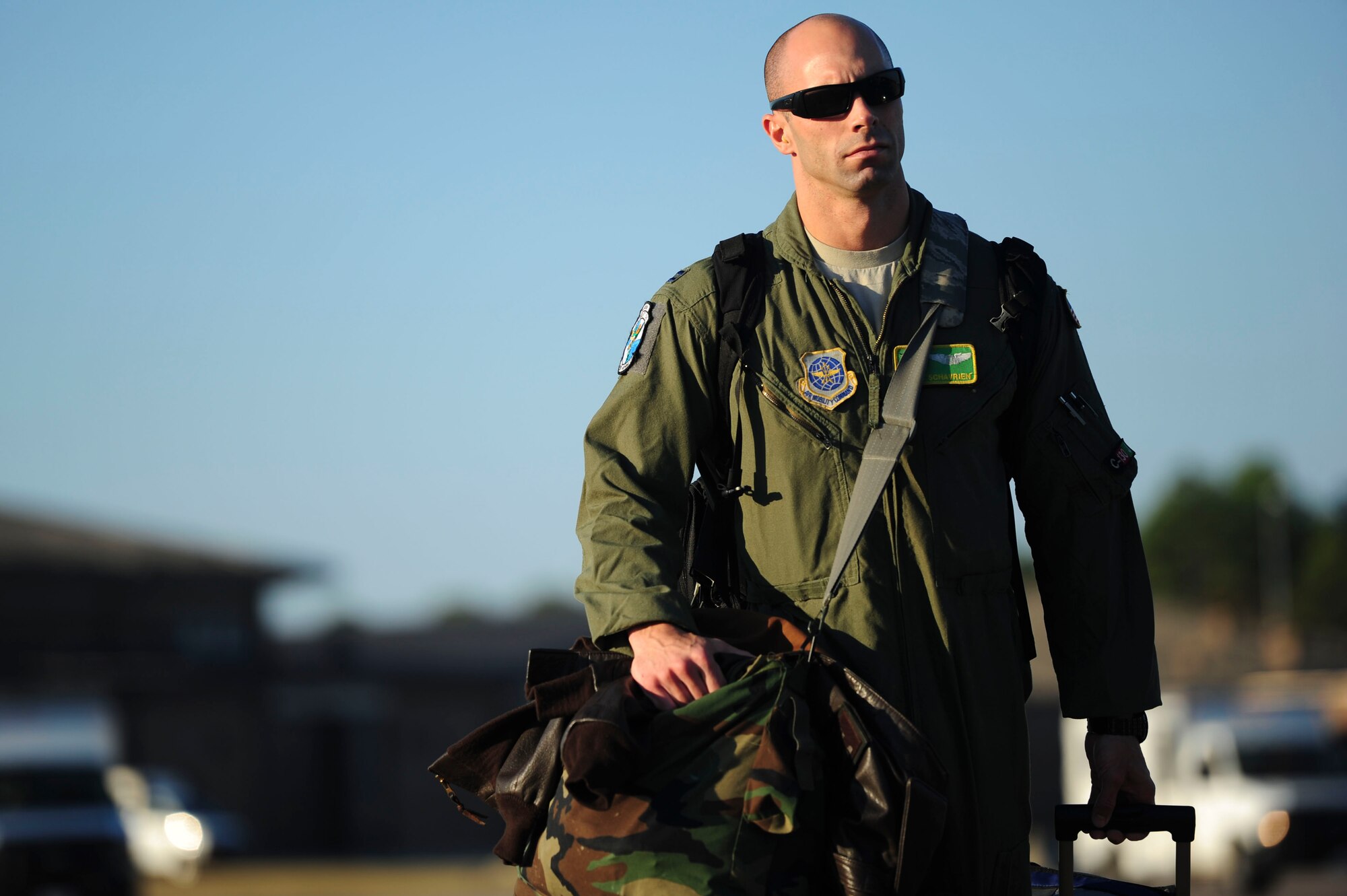 Capt. Scott Schavrien, a 61st Airlift Squadron pilot, carries his bags to load a C-130J for RED FLAG Alaska Sept. 29, 2014, at Little Rock Air Force Base, Ark. RED FLAG Alaska is a joint, multinational field training exercise designed to provide offensive counter-air, interdiction, close air support, and large force employment training in a simulated combat environment. (U.S. Air Force photo by Senior Airman Kaylee Clark)
