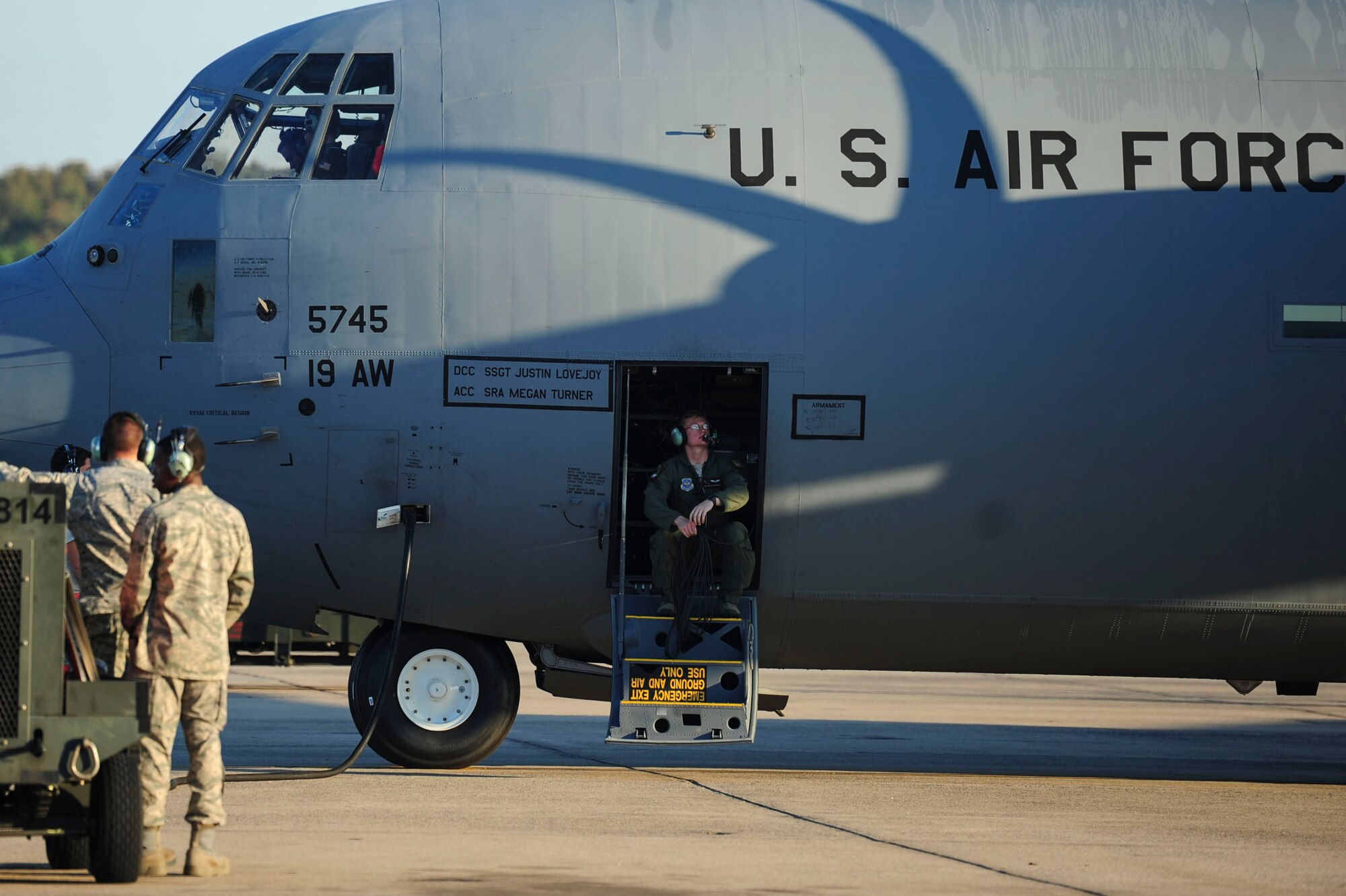A 41st Airlift Squadron loadmaster sits on the stairs of a C-130J waiting for startup Sept. 29, 2014, at Little Rock Air Force Base, Ark. Loadmasters are responsible for supervising the loading and unloading of cargo, vehicles and passengers on the aircraft. (U.S. Air Force photo by Senior Airman Kaylee Clark)