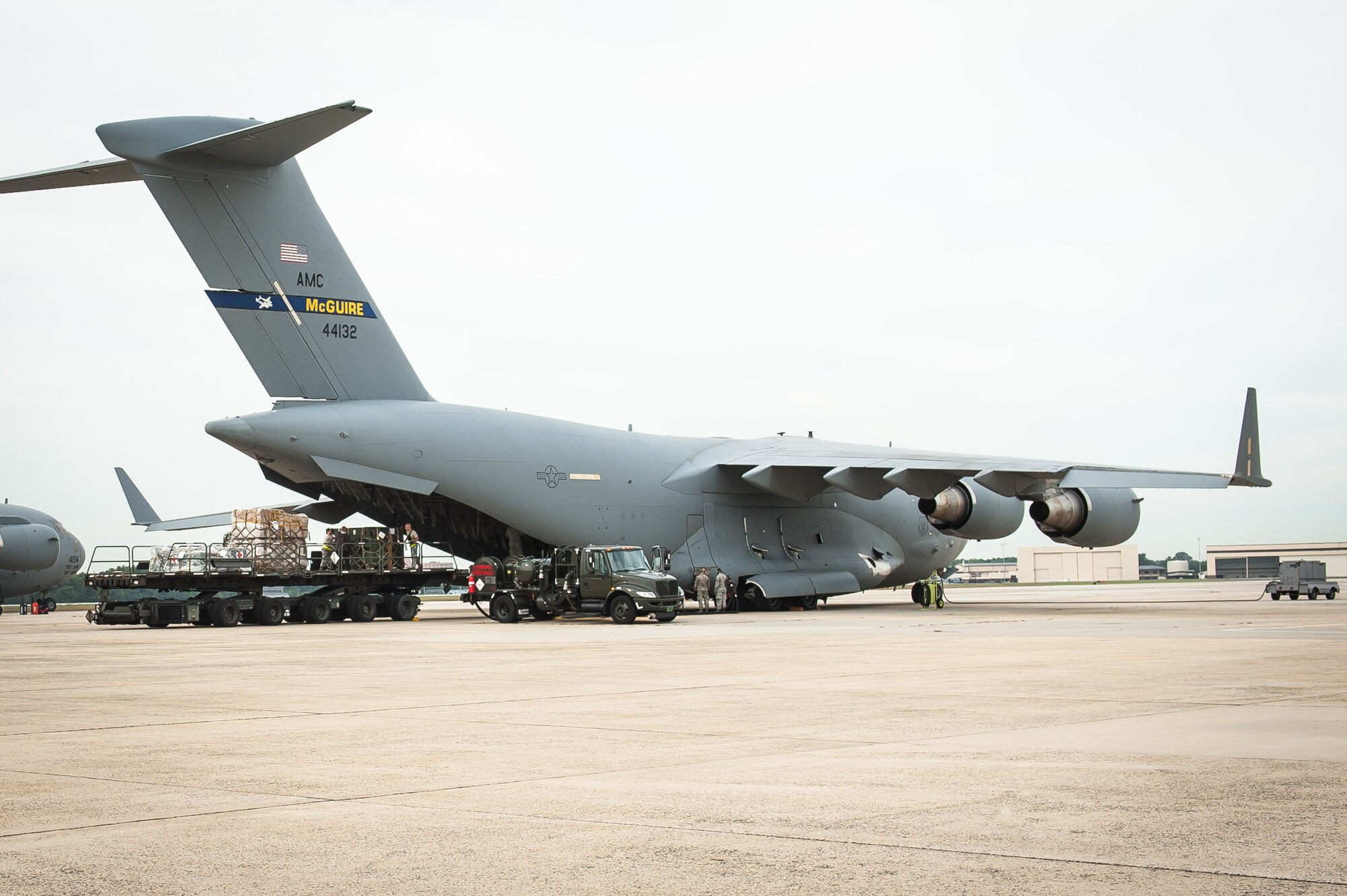 JOINT BASE MCGUIRE-DIX-LAKEHURST, N.J. - Airmen from the 305th Air Mobility Wing load cargo from the 621st Contingency Response Wing onto a Globemaster III C-17 before they deploy to West Africa here, Sept. 24, 2014. The 621st Contingency Response Wing's alert unit, 817th Contingency Response Group, is deploying to West Africa in support of Operation UNITED ASSISTANCE in response to the Ebola virus disease outbreak. The 621st Contingency Response Wing is highly-specialized in training and rapidly deploying personnel to quickly open airfields and establish, expand, sustain, and coordinate air mobility operations. From wartime taskings to disaster relief, the 621st extends Air Mobility Command's reach in deploying people and equipment around the globe. (U.S. Air Force photo by Russell Meseroll)