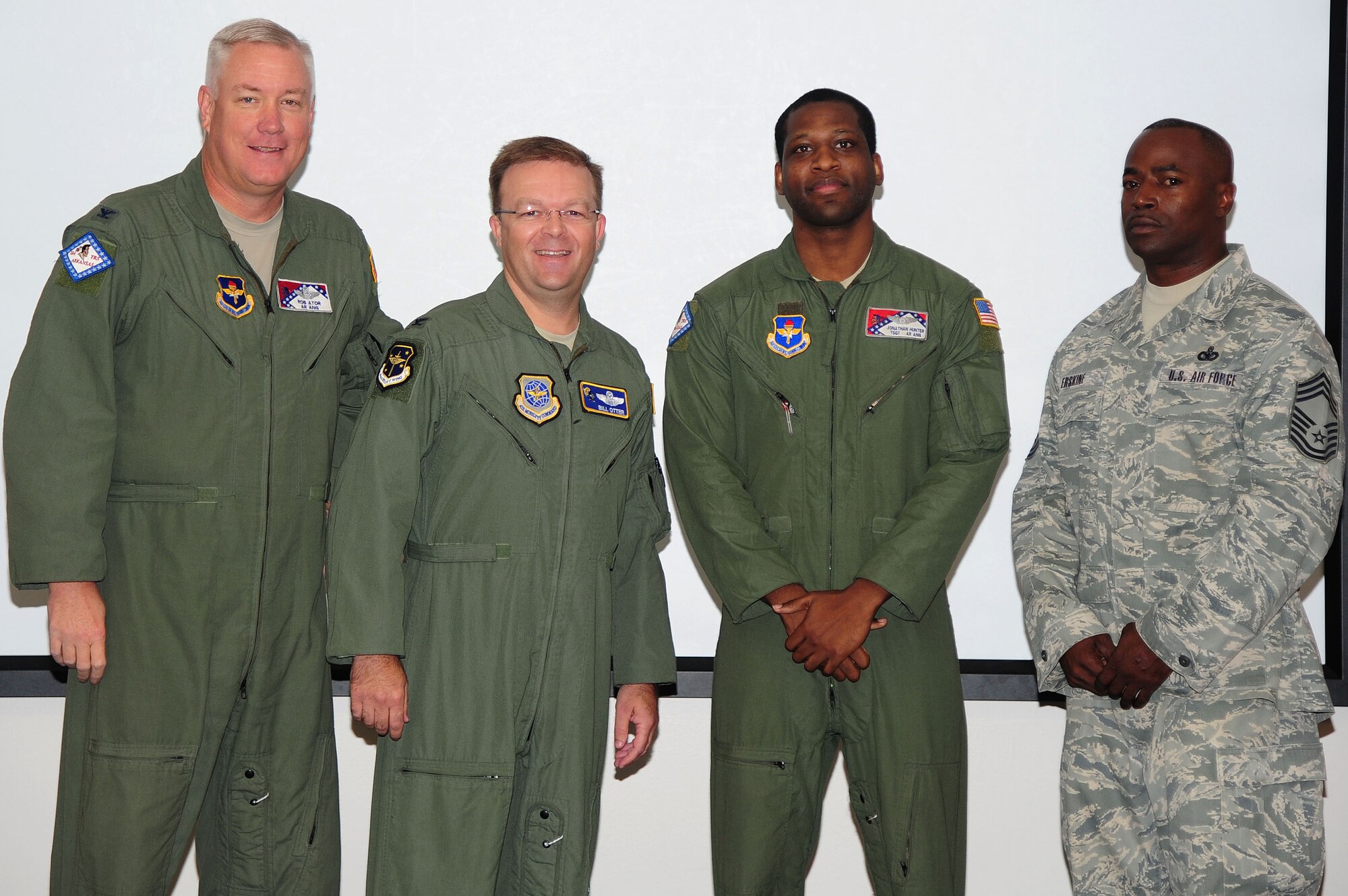 Col. Robert Ator II, 189th Airlift Wing commander, along with Col. William Otter, 19th Airlift Wing vice commander, and Chief Master Sgt. Anthony Erskine, 19th Mission Support Group superintendent, congratulate Tech. Sgt. Jonathan Hunter, a 189th Airlift Wing C130H formal training unit instructor and joint airdrop inspector loadmaster, for his selection as Combat Airlifter of the Week Sept. 30, 2014, at Little Rock Air Force Base, Ark. Hunter a Little Rock, Ark. native, works with active-duty counterparts daily to ensure the Formal Training Unit  produces mission-ready enlisted aviators. (U.S. Air Force photo by Senior Airman Kaylee Clark)