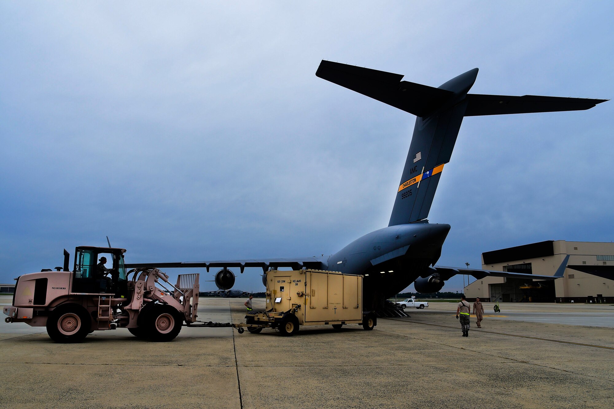 JOINT BASE MCGUIRE-DIX-LAKEHURST, N.J. - Airmen from the 621st Contingency Response Wing and 15th Airlift Squadron, assigned to Joint Base Charleston, N.C., load a CRW Hardside Expandable Light Air-Mobile Shelter (HELAMS) onto a Globemaster III C-17, also from JB Charleston, here, Sept. 29, 2014. The HELAMS will be used by the 621 CRW in West Africa in support of Operation UNITED ASSISTANCE in response to the Ebola virus disease outbreak. The CRW is highly-specialized in training and rapidly deploying personnel to quickly open airfields and establish, expand, sustain, and coordinate air mobility operations. From wartime taskings to disaster relief, the CRW extends Air Mobility Command's reach in deploying people and equipment around the globe. (U.S. Air Force photo by Staff Sgt. Gustavo Gonzalez/Released)