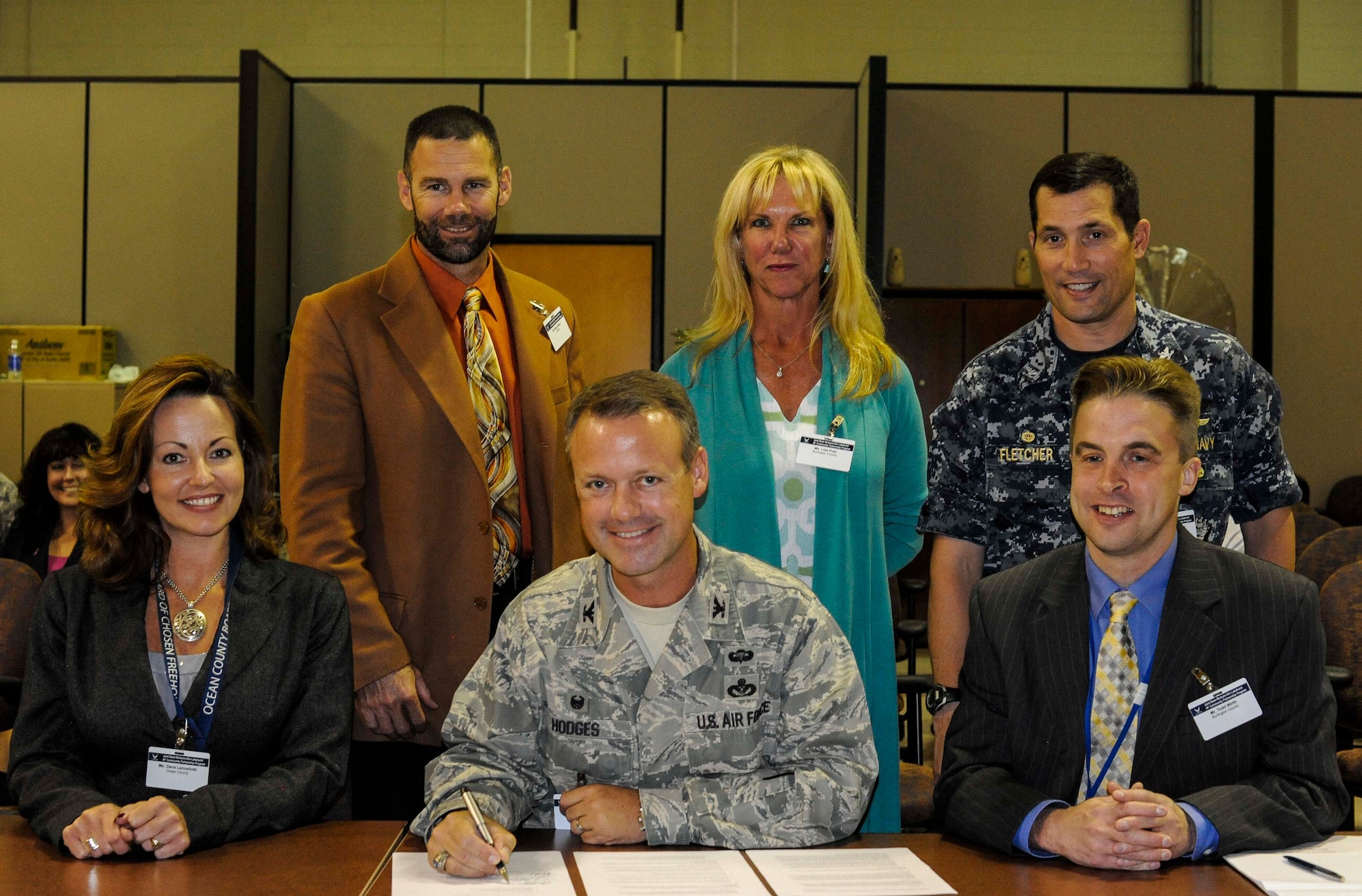 Joint base and Ocean County and Burlington County leaders sign a charter establishing the Community Partnership Executive Committee as part of the Air Force Community Partnership Program Sept. 23, 2014, at Joint Base McGuire-Dix-Lakehurst, N.J. The purpose of the AFCPP is to leverage installation and local community capabilities and resources to identify and develop mutually beneficial partnerships to increase efficiency, retain or enhance quality and reduce operating and service costs or risks. (U.S. Air Force photo by Senior Airman Ryan Throneberry/Released)
