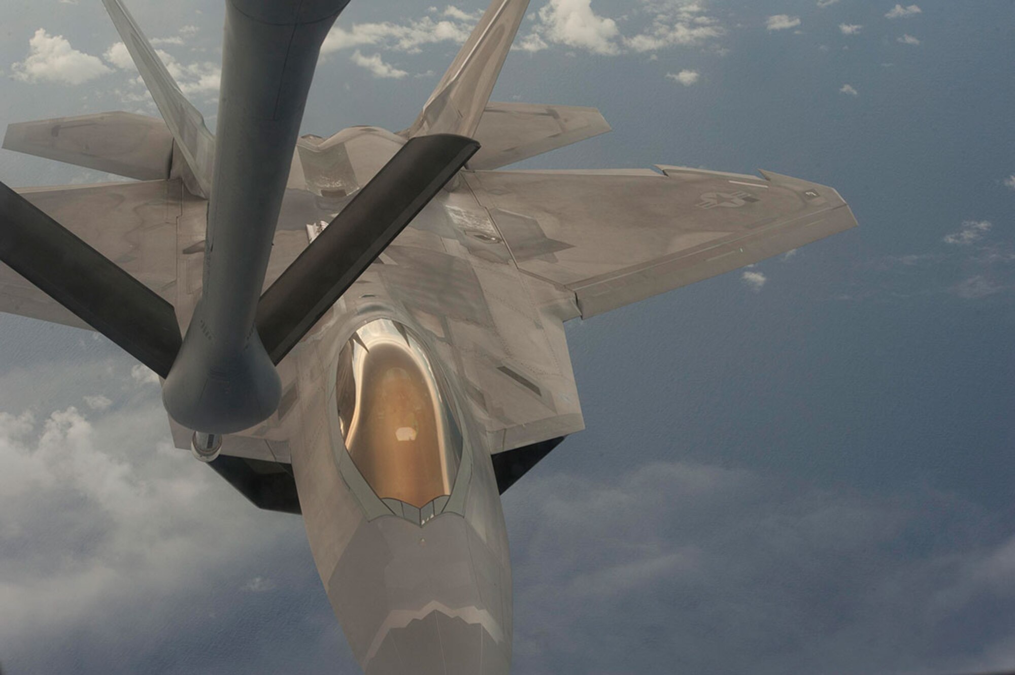 PACIFIC OCEAN ( 19 Sept. 2014) -- A U.S. Air Force F-22 Raptor from the 90th Fighter Squadron from Joint Base Elmendorf Richardson prepares to refuel from a KC-135 Stratotanker during exercise Valiant Shield, Sept. 19, 2014.Valiant Shield is a U.S.-only exercise integrating and estimated 18,000 Navy, Air Force, Army and Marine Corps personnel, more than 200 aircraft and 19 surface ships, offering real-world joint operational experience to develop capabilities that provide a full range of options to defend U.S. interests and those of its allies and partners.