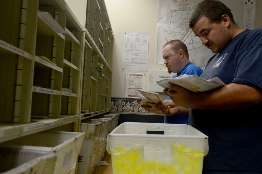 (From left) Russell Shirer and James Bacvinskas, 20th Communications Squadron general mail clerks, sort through mail at Shaw Air Force Base, S.C., Oct. 2, 2014. The mail clerks are in charge of all official mail ensuring mail is safe before it is distributed on base. In order to work in the mail room, a 12 to 14 months training is required. (U.S. Air Force photo by Senior Airman Ashley L. Gardner/Released)