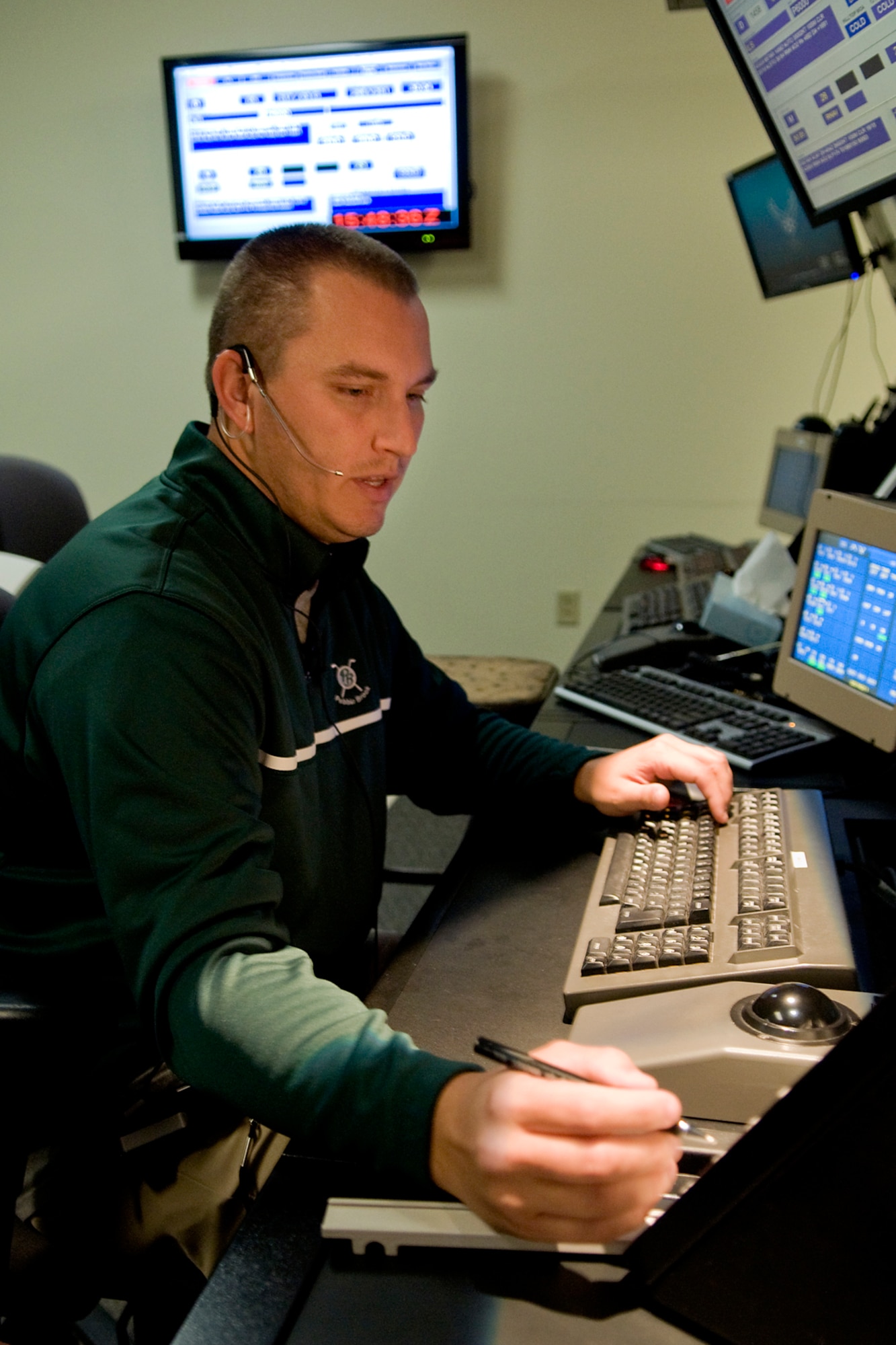 Keith Atkinson, 434th Operations Support Squadron air traffic control specialist, writes down an aircraft's flight plan information as he manages air traffic at Grissom Air Reserve Base, Ind., Sept. 29, 2014. Flight data strips are normally printed through an automated system, but in the aftermath of a fire at Chicago's Air Route Traffic Control Center, Grissom controllers were forced to manually coordinate flight data with surrounding approach control facilities. (U.S. Air Force photo/Mark R. W. Orders-Woempner)