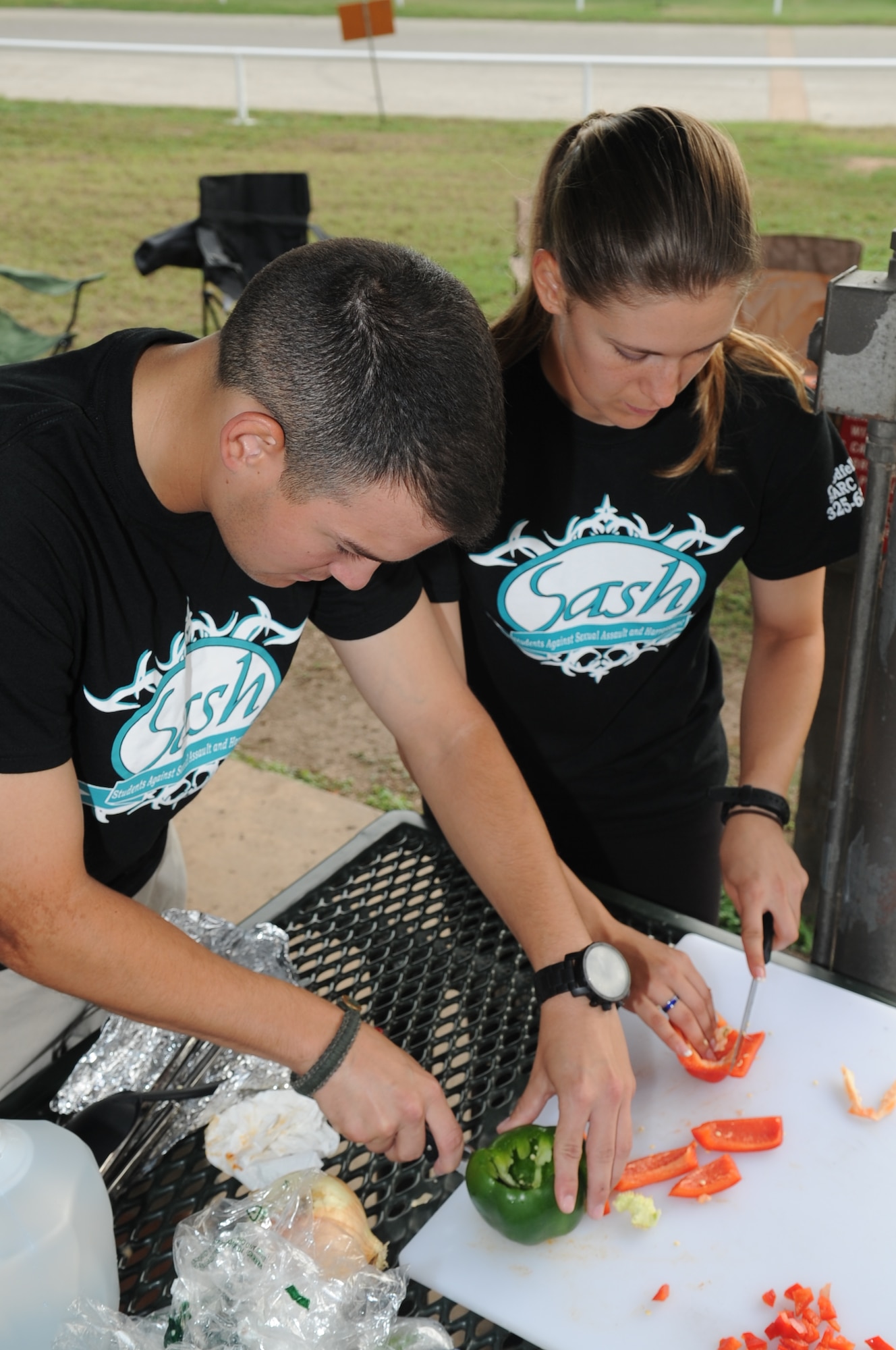 GOODFELLOW AIR FORCE BASE, Texas -- Airman William K. Cook and Airman 1st Class Jazmine N. Linger, 315th Training Squadron students, cut ingredients for their team’s chili during the 41st Annual Armed Forces Chili Cook-off at the Recreation Camp Sept. 27. In addition to hosting the chili cook-off, the Recreation Camp offers a variety of outdoor activities to give members a reason to get out of the house. (U.S. Air Force photo/ Staff Sgt. Laura R. McFarlane)