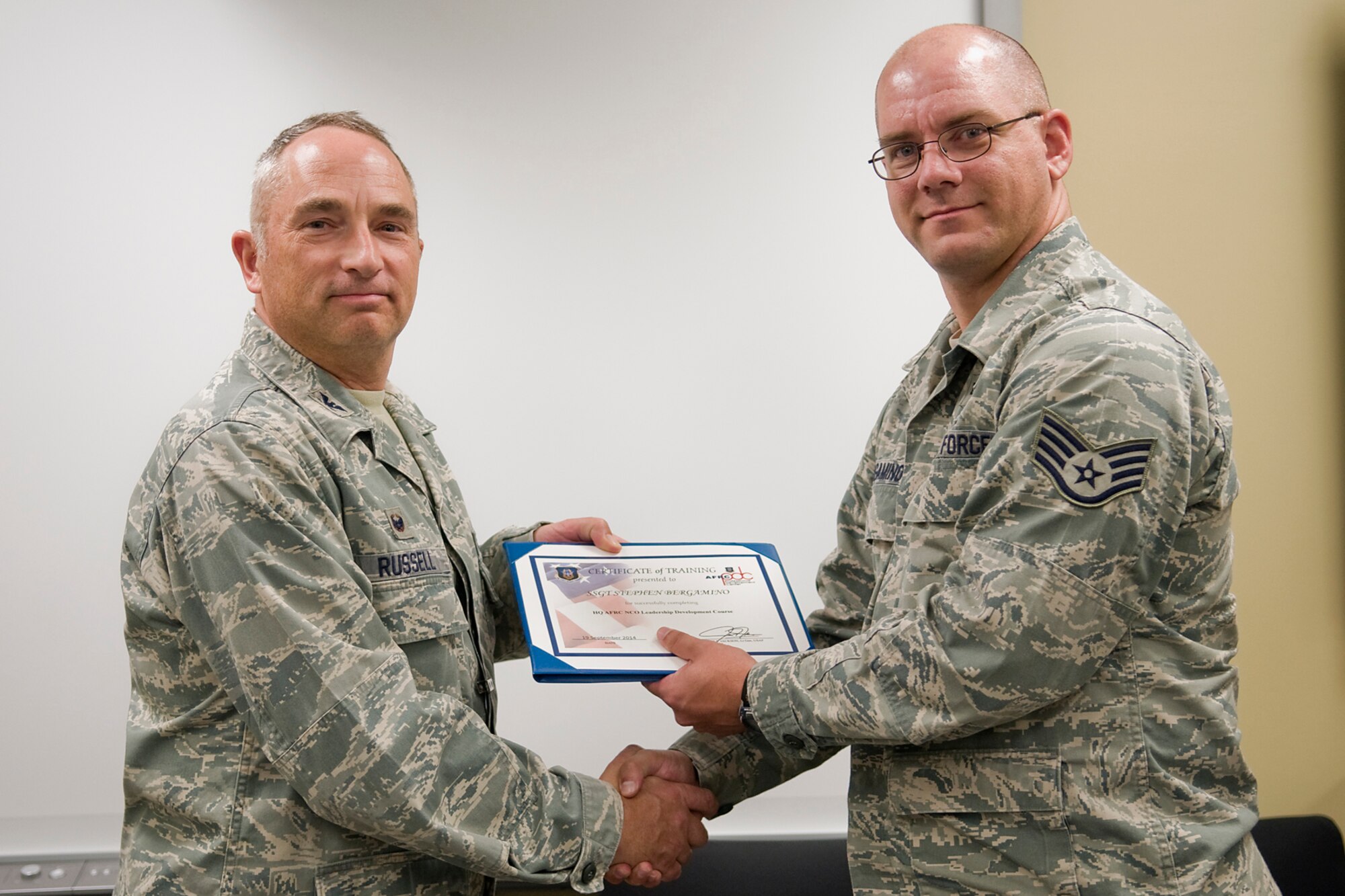 Col. Scott Russell, 434th Mission Support Group commander, left, presents Staff Sgt. Stephen Bergameno, 434th Aircraft Maintenance Squadron KC-135 crew chief, with a certificate of completion from an Air Force Reserve Noncommissioned Officer Leadership Development Course at Grissom Air Reserve Base, Ind., Sept. 19, 2014. The 10-day course combined college level management and leadership instruction with a military practical, experimental and hands-on application. (U.S. Air Force photo/Mark R. W. Orders-Woempner)
