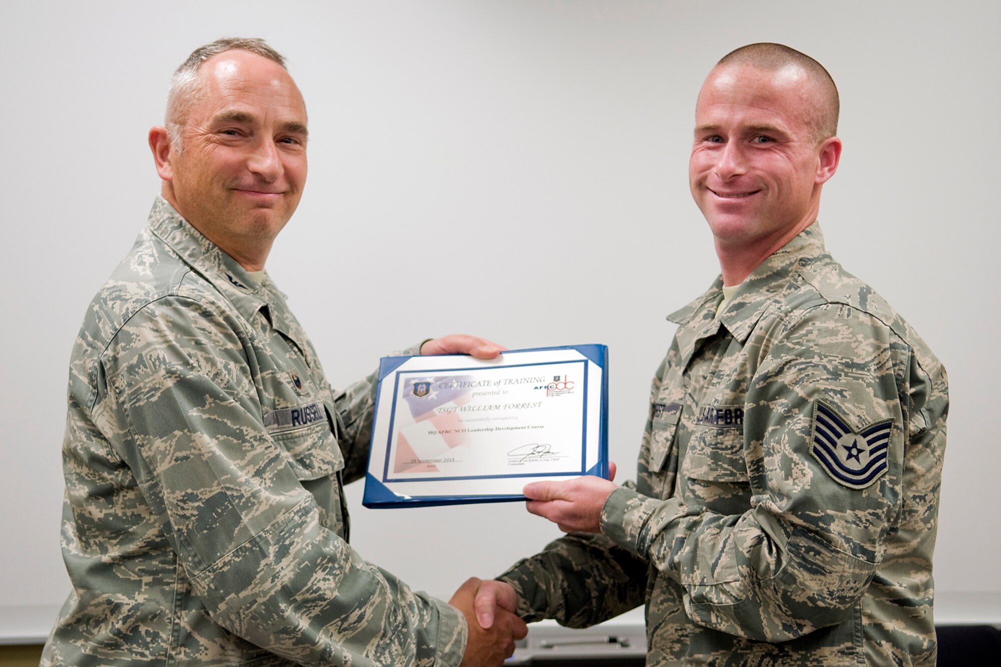 Col. Scott Russell, 434th Mission Support Group commander, left, presents Tech. Sgt. William Forrest, 434th Logistics Readiness Squadron supply management craftsman, with a certificate of completion from an Air Force Reserve Noncommissioned Officer Leadership Development Course at Grissom Air Reserve Base, Ind., Sept. 19, 2014. The 10-day course combined college level management and leadership instruction with a military practical, experimental and hands-on application. (U.S. Air Force photo/Mark R. W. Orders-Woempner)

