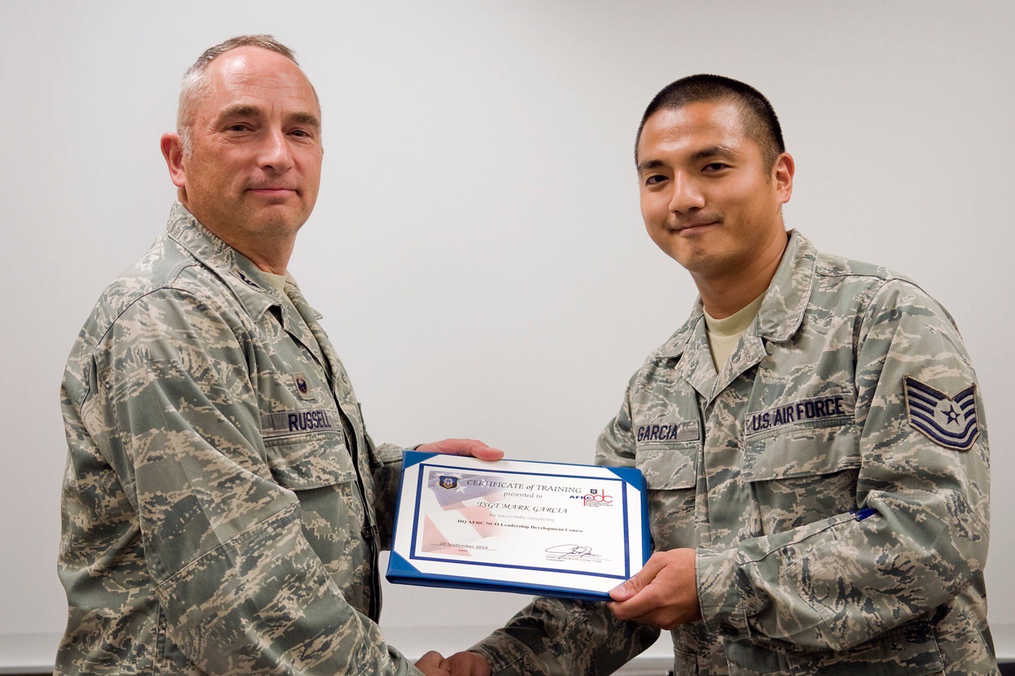 Col. Scott Russell, 434th Mission Support Group commander, left, presents Tech. Sgt. Mark Garcia, 434th Logistics Readiness Squadron materiel management craftsman, with a certificate of completion from an Air Force Reserve Noncommissioned Officer Leadership Development Course at Grissom Air Reserve Base, Ind., Sept. 19, 2014. The 10-day course combined college level management and leadership instruction with a military practical, experimental and hands-on application. (U.S. Air Force photo/Mark R. W. Orders-Woempner)

