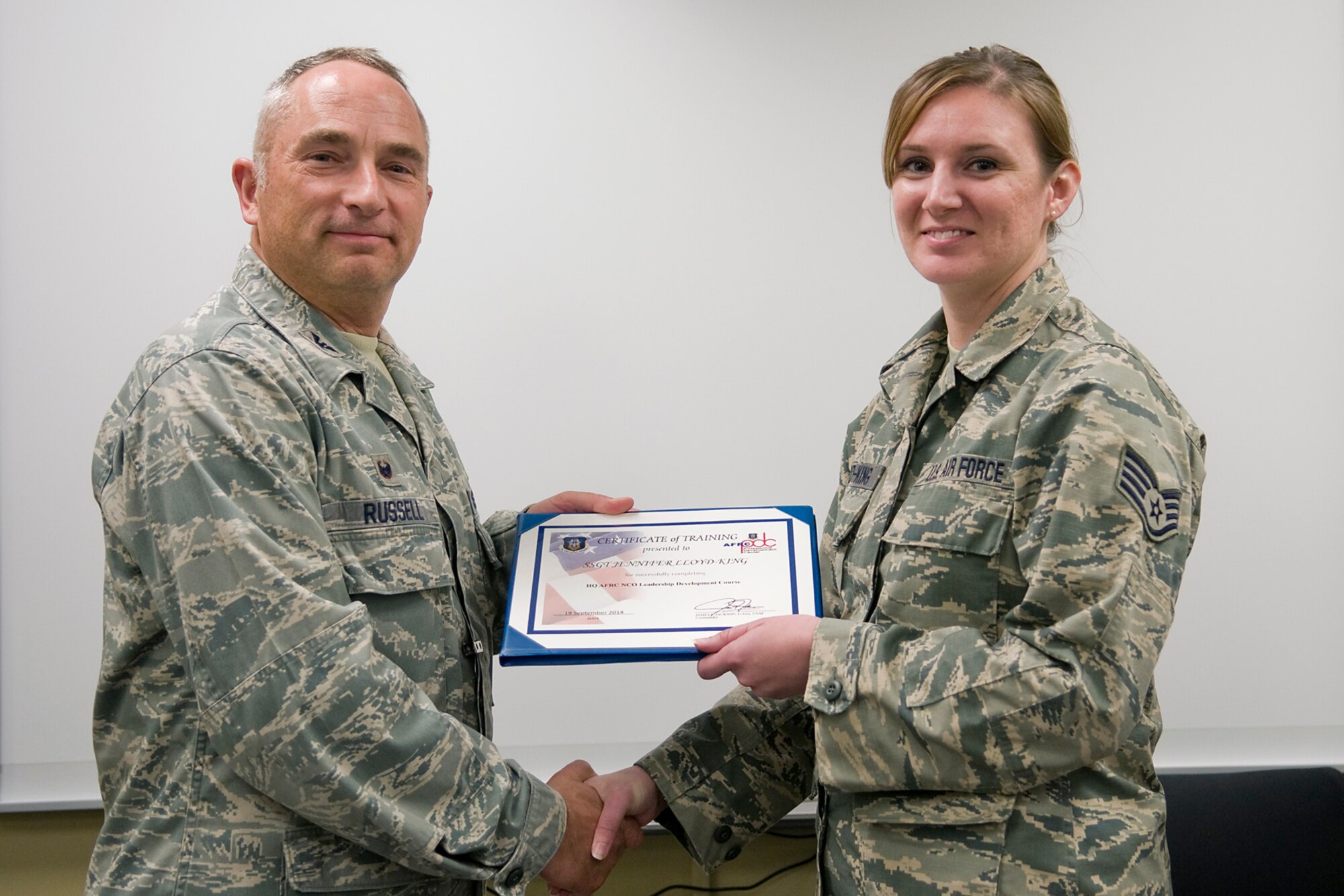 Col. Scott Russell, 434th Mission Support Group commander, left, presents Staff Sgt. Jennifer Lloyd-King, 434th Aerospace Medicine Squadron health service management journeyman, with a certificate of completion from an Air Force Reserve Noncommissioned Officer Leadership Development Course at Grissom Air Reserve Base, Ind., Sept. 19, 2014. The 10-day course combined college level management and leadership instruction with a military practical, experimental and hands-on application. (U.S. Air Force photo/Mark R. W. Orders-Woempner)

