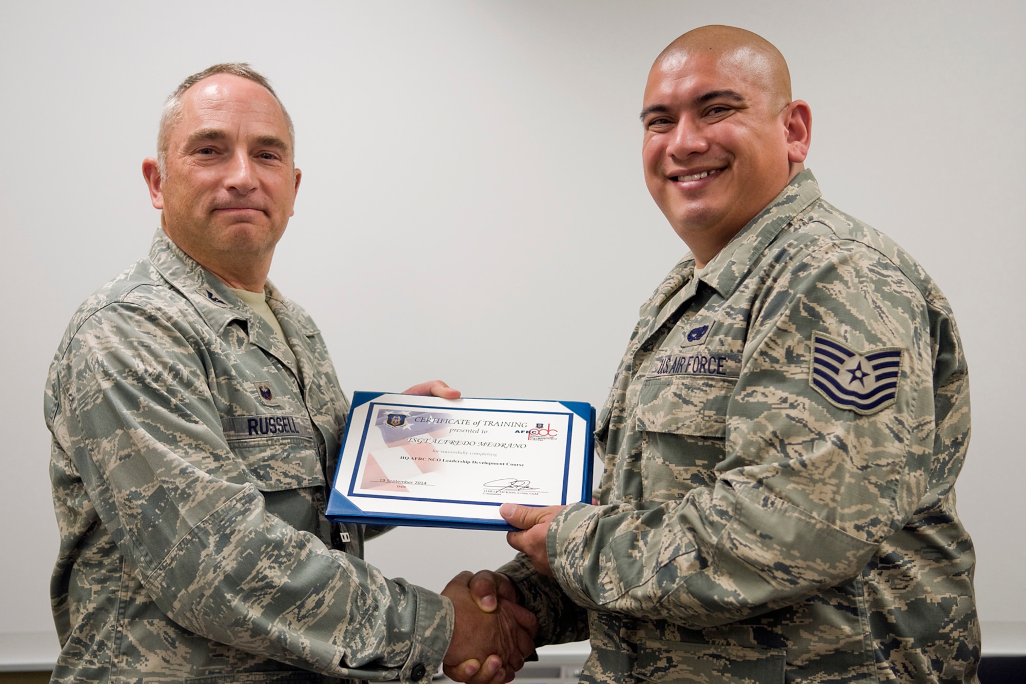 Col. Scott Russell, 434th Mission Support Group commander, left, presents Tech. Sgt. Alfredo Medrano, 924th Maintenace Squadron, with a certificate of completion from an Air Force Reserve Noncommissioned Officer Leadership Development Course at Grissom Air Reserve Base, Ind., Sept. 19, 2014. The 10-day course combined college level management and leadership instruction with a military practical, experimental and hands-on application. (U.S. Air Force photo/Mark R. W. Orders-Woempner)
