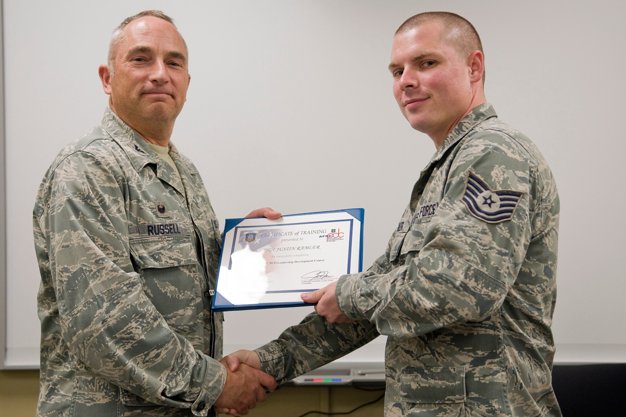 Col. Scott Russell, 434th Mission Support Group commander, left, presents Tech. Sgt. Justin Ramler, 434th Logistics Readiness Squadron materiel management craftsman, with a certificate of completion from an Air Force Reserve Noncommissioned Officer Leadership Development Course at Grissom Air Reserve Base, Ind., Sept. 19, 2014. The 10-day course combined college level management and leadership instruction with a military practical, experimental and hands-on application. (U.S. Air Force photo/Mark R. W. Orders-Woempner)
