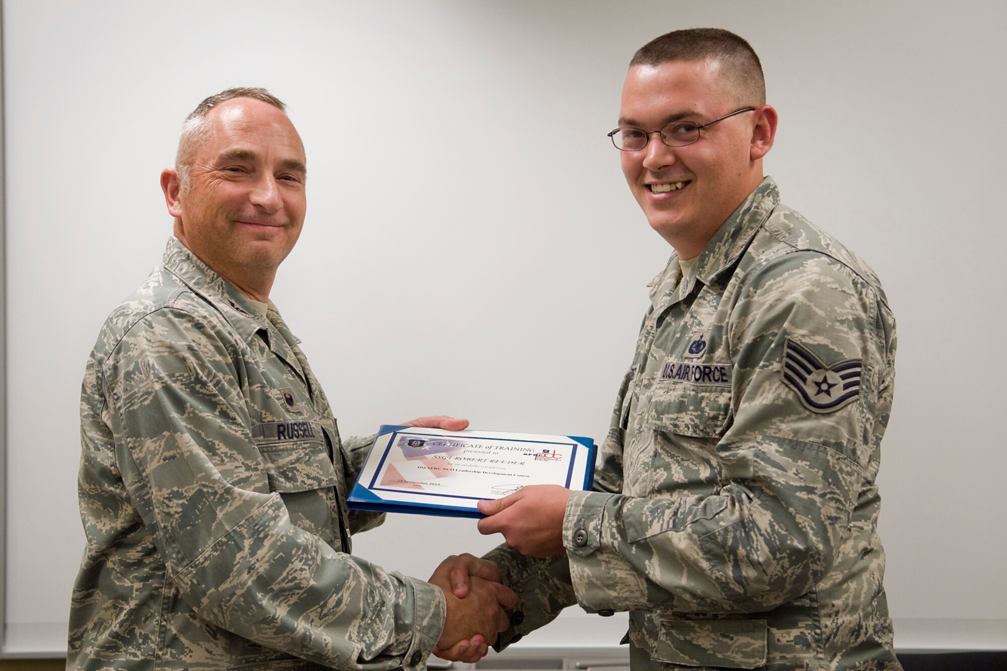 Col. Scott Russell, 434th Mission Support Group commander, left, presents Staff Sgt. Robert Reeder, 434th Logistics Readiness Squadron fuels craftsman, with a certificate of completion from an Air Force Reserve Noncommissioned Officer Leadership Development Course at Grissom Air Reserve Base, Ind., Sept. 19, 2014. The 10-day course combined college level management and leadership instruction with a military practical, experimental and hands-on application. (U.S. Air Force photo/Mark R. W. Orders-Woempner)
