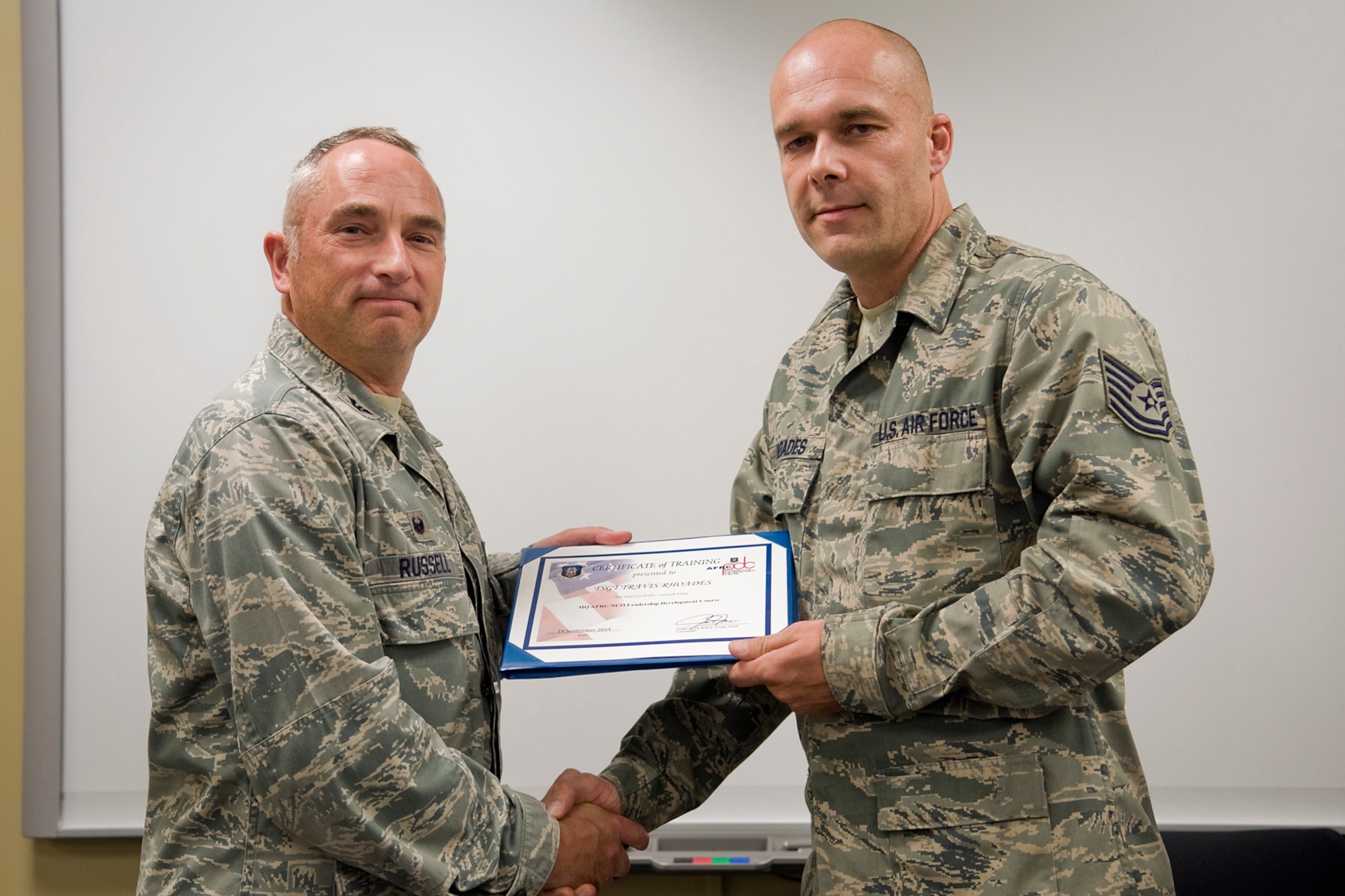 Col. Scott Russell, 434th Mission Support Group commander, left, presents Tech. Sgt. Travis Rhoades, 434th Maintenance Squadron KC-135 crew chief, with a certificate of completion from an Air Force Reserve Noncommissioned Officer Leadership Development Course at Grissom Air Reserve Base, Ind., Sept. 19, 2014. The 10-day course combined college level management and leadership instruction with a military practical, experimental and hands-on application. (U.S. Air Force photo/Mark R. W. Orders-Woempner)
