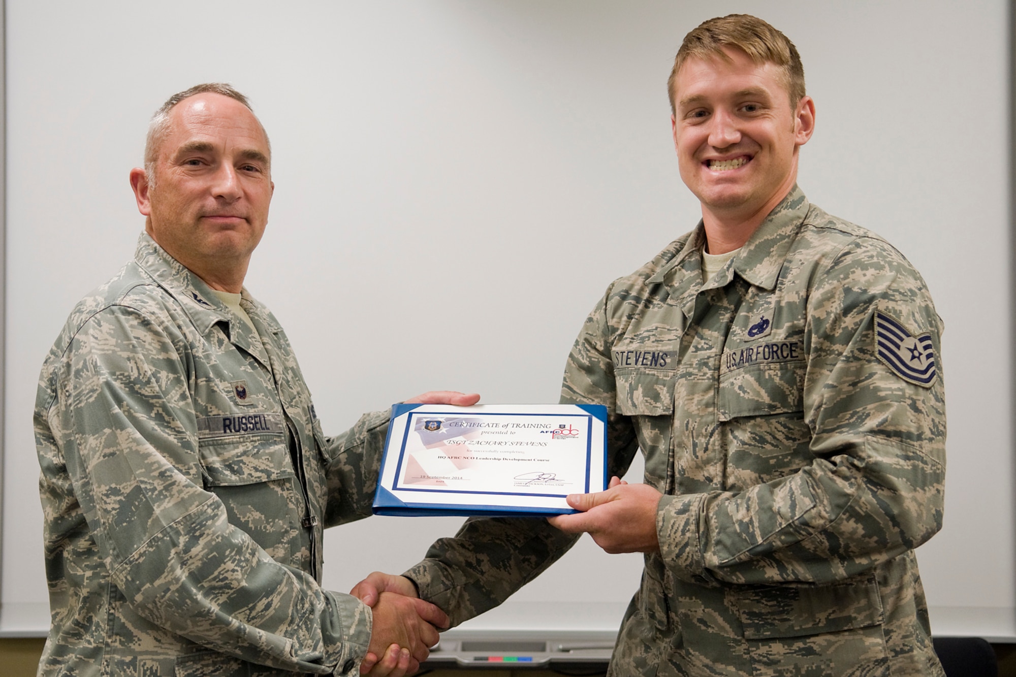 Col. Scott Russell, 434th Mission Support Group commander, left, presents Tech. Sgt. Zachary Stevens, 924th Maintenance Squadron, with a certificate of completion from an Air Force Reserve Noncommissioned Officer Leadership Development Course at Grissom Air Reserve Base, Ind., Sept. 19, 2014. The 10-day course combined college level management and leadership instruction with a military practical, experimental and hands-on application. (U.S. Air Force photo/Mark R. W. Orders-Woempner)
