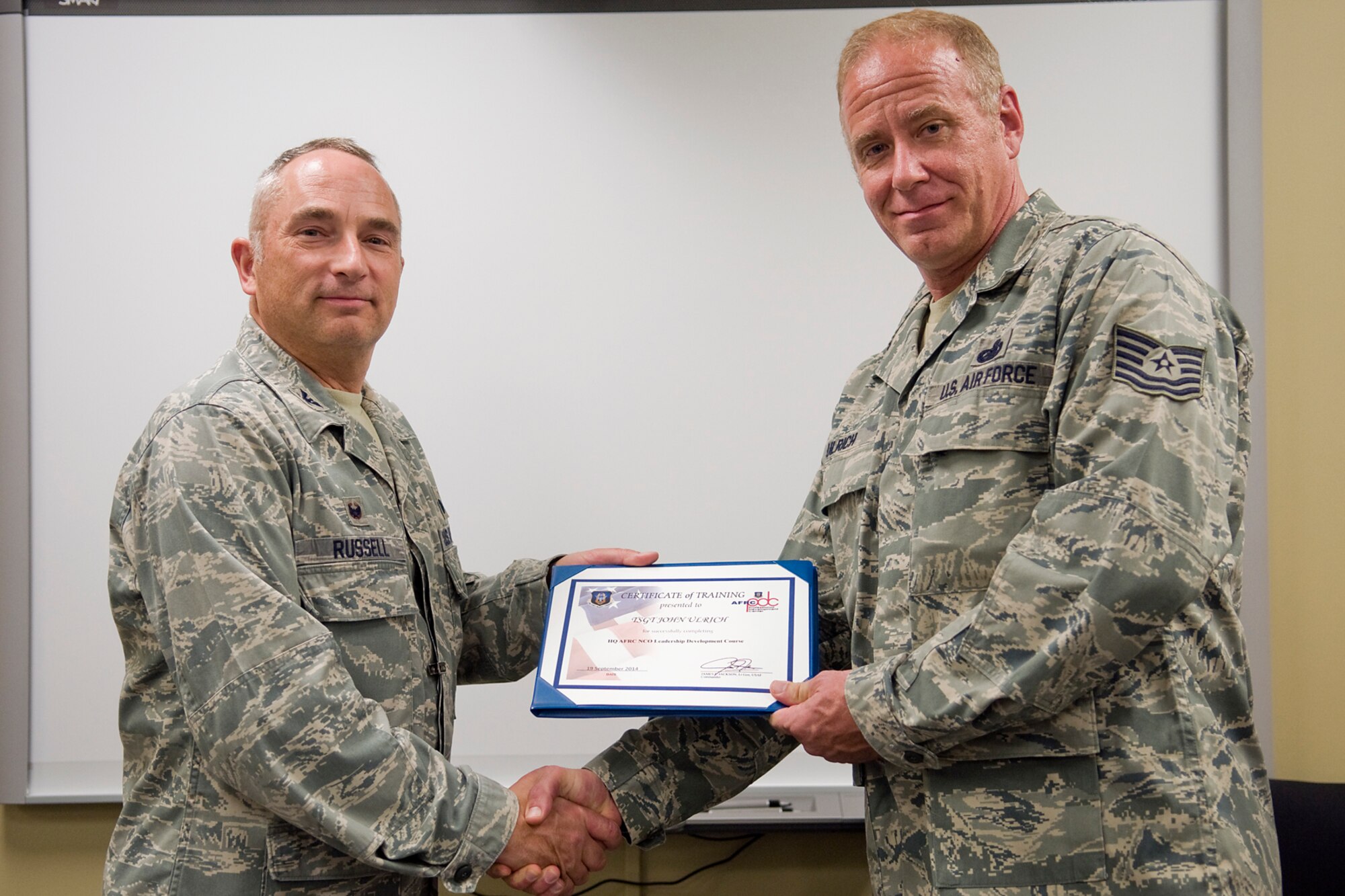 Col. Scott Russell, 434th Mission Support Group commander, left, presents Tech. Sgt. John Ulrich, 434th Logistics Readiness Squadron supply management journeyman, with a certificate of completion from an Air Force Reserve Noncommissioned Officer Leadership Development Course at Grissom Air Reserve Base, Ind., Sept. 19, 2014. The 10-day course combined college level management and leadership instruction with a military practical, experimental and hands-on application. (U.S. Air Force photo/Mark R. W. Orders-Woempner)
