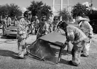 Firefighters from the 96th Test Wing set down a car roof after removing it during a car extraction training exercise at Duke Field, Fla., Sept. 10.  The day crew of Fire Station 4 took part in the exercise to meet their training requirement.  National Fire Prevention Week began Oct. 5.  Eglin firefighters have various activities planned throughout the week.   (U.S. Air Force photo/Tech. Sgt. Sam King)