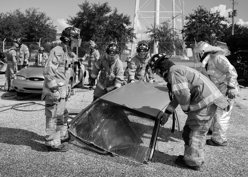 Firefighters from the 96th Test Wing set down a car roof after removing it during a car extraction training exercise at Duke Field, Fla., Sept. 10.  The day crew of Fire Station 4 took part in the exercise to meet their training requirement.  National Fire Prevention Week began Oct. 5.  Eglin firefighters have various activities planned throughout the week.   (U.S. Air Force photo/Tech. Sgt. Sam King)