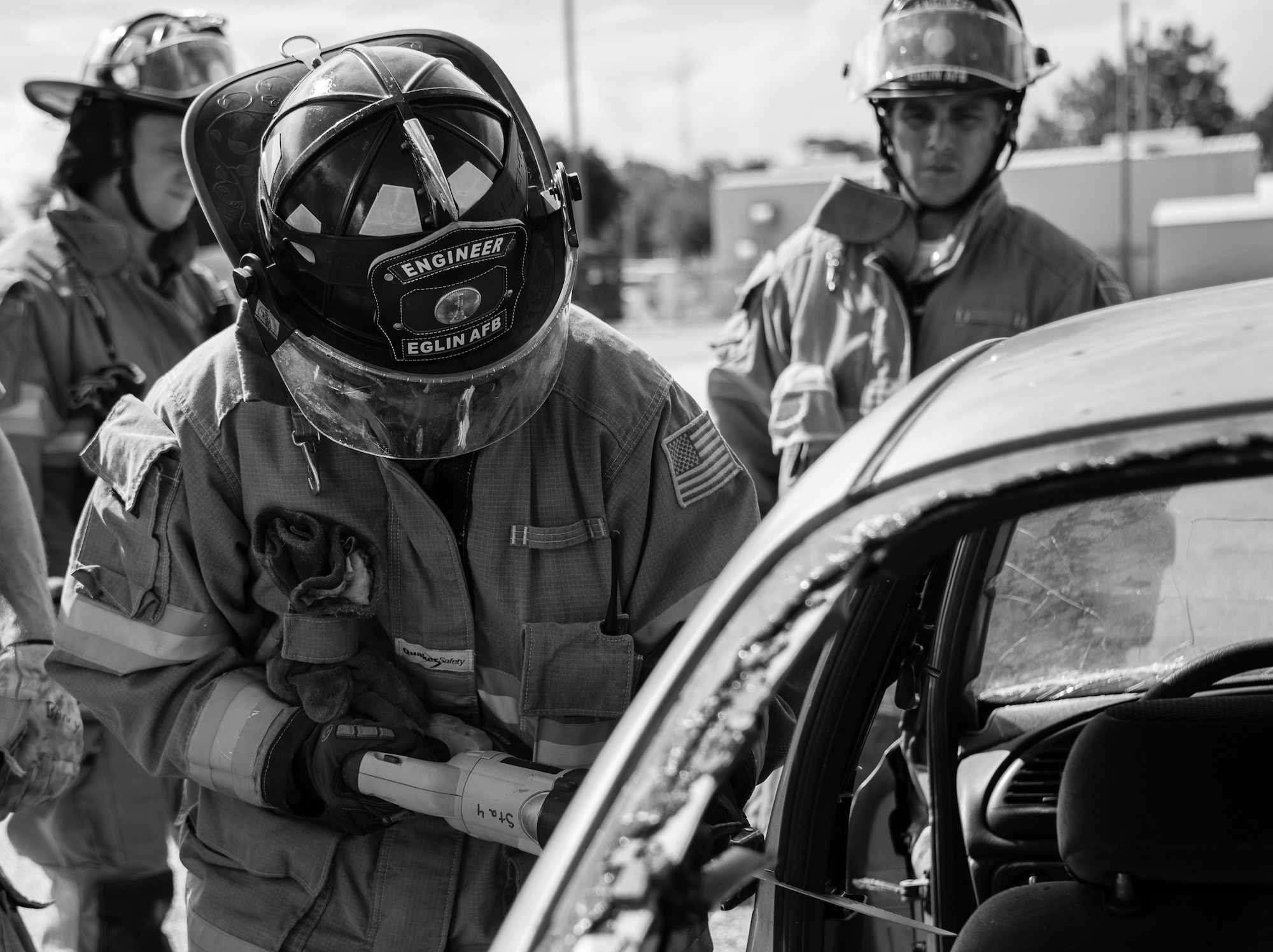 A 96th Test Wing begins cutting the car frame with a hand saw during an extraction training exercise at Duke Field, Fla., Sept. 10.  The day crew of Fire Station 4 took part in the exercise to meet their training requirement.  National Fire Prevention Week began Oct. 5.  Eglin firefighters have various activities planned throughout the week.   (U.S. Air Force photo/Tech. Sgt. Sam King)