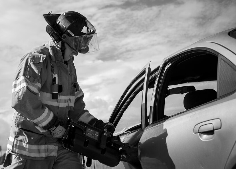 A 96th Test Wing firefighter uses a prying tool to open the car door during an extraction training exercise at Duke Field, Fla., Sept. 10.  The day crew of Fire Station 4 took part in the exercise to meet their training requirement.  National Fire Prevention Week began Oct. 5.  Eglin firefighters have various activities planned throughout the week.   (U.S. Air Force photo/Tech. Sgt. Sam King)