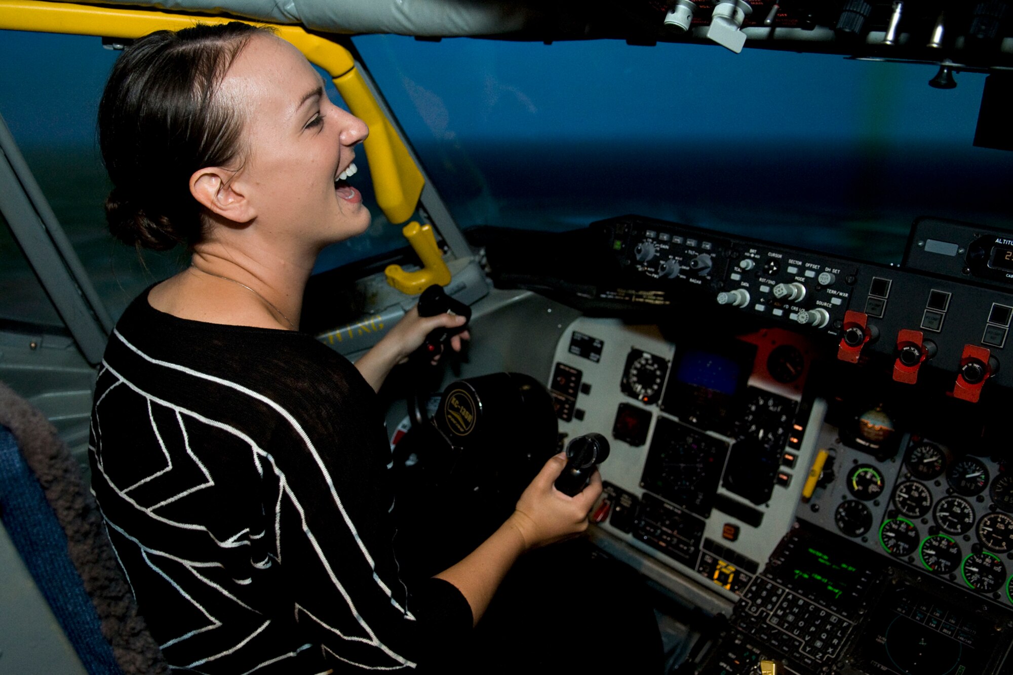Rachel Lipsey, military legislative assistant for Sen. Joe Donnelly, is all smiles as she takes the controls of a KC-135R Stratotanker simulator at Grissom Air Reserve Base, Ind., Sept. 4, 2014. Lipsey toured the north-central Indiana base to learn more about the Air Force Reserve and its mission. (U.S. Air Force photo/Mark R. W. Orders-Woempner)