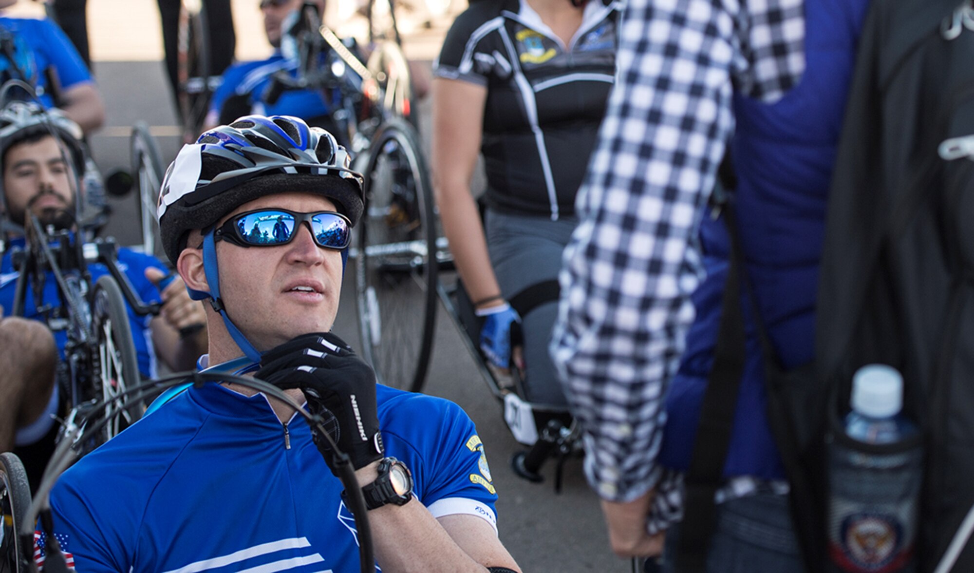 Former Senior Airman Jeremiah Means speaks to his wife Ashley before his race begins at the Warrior Games cycling event Sept. 29, 2014, at Fort Carson, Colorado. Ashley serves as a caretaker for Jeremiah, a former senior airman and wounded warrior athlete. (U.S. Air Force photo/Senior Airman Jette Carr)