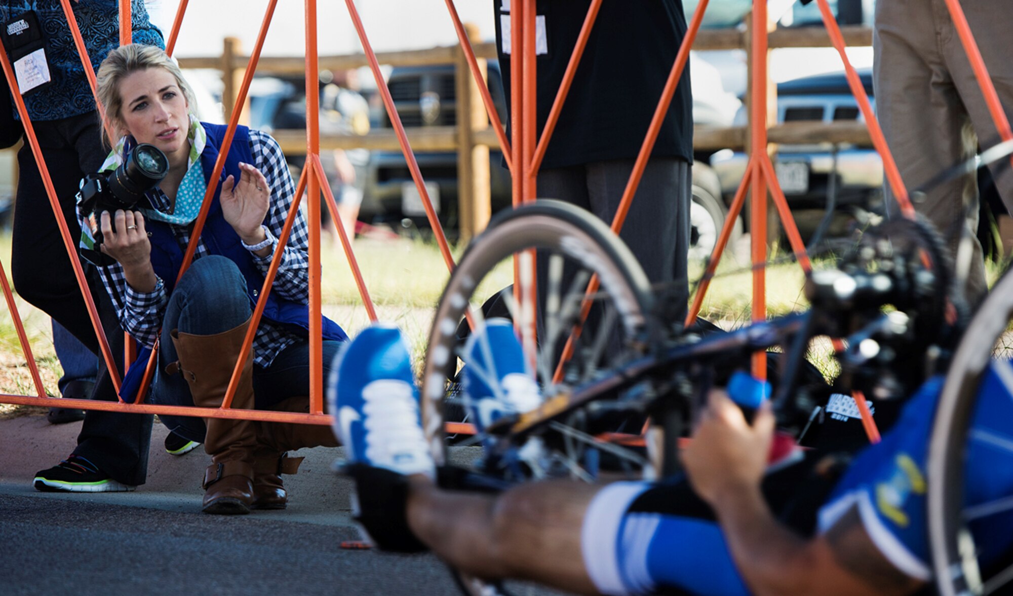 Ashley Means watches for her husband Jeremiah at the finish line of the Warrior Games cycling event Sept. 29, 2014, at Fort Carson, Colorado. Ashley serves a s a caretaker for Jeremiah, a former senior airman and wounded warrior. (U.S. Air Force photo/Senior Airman Jette Carr)