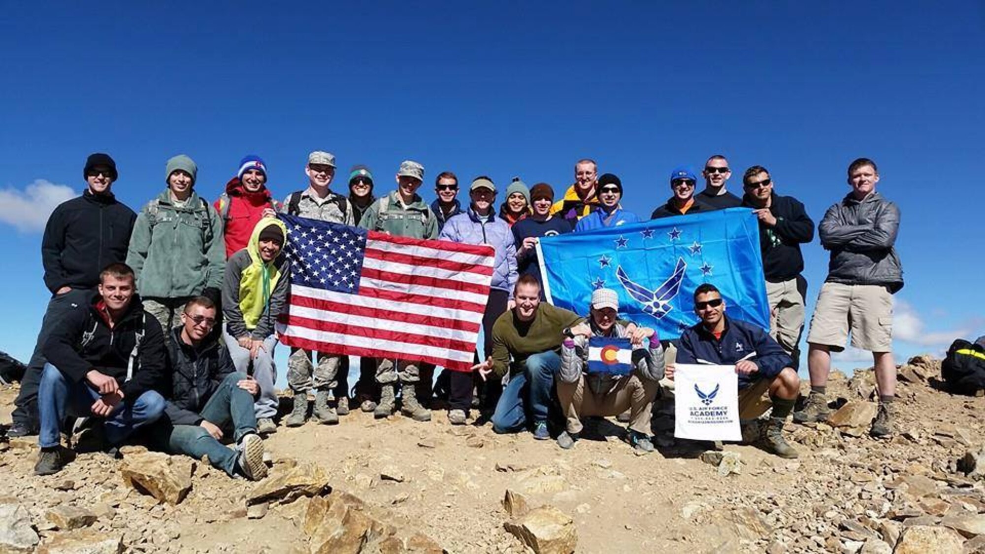 U.S. Air Force Academy and Schriever Air Force Base Airmen hold a U.S. and an Air Force flag at the top of Mount Elbert Sept. 20, 2014. The Airmen climbed the mountain in cooperation with the 50 Summits Challenge, which involves climbing to the highest point of each state with the flags. (Courtesy photo)