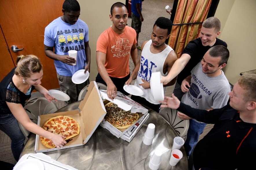 Airmen serve themselves pizza during a video game tournament for dorm residents Sept. 28, 2014 at Moody Air Force Base, Ga. The event included gaming, free food and beverages, and a movie. (U.S. Air Force photo by Senior Airman Sandra Marrero/Released)
