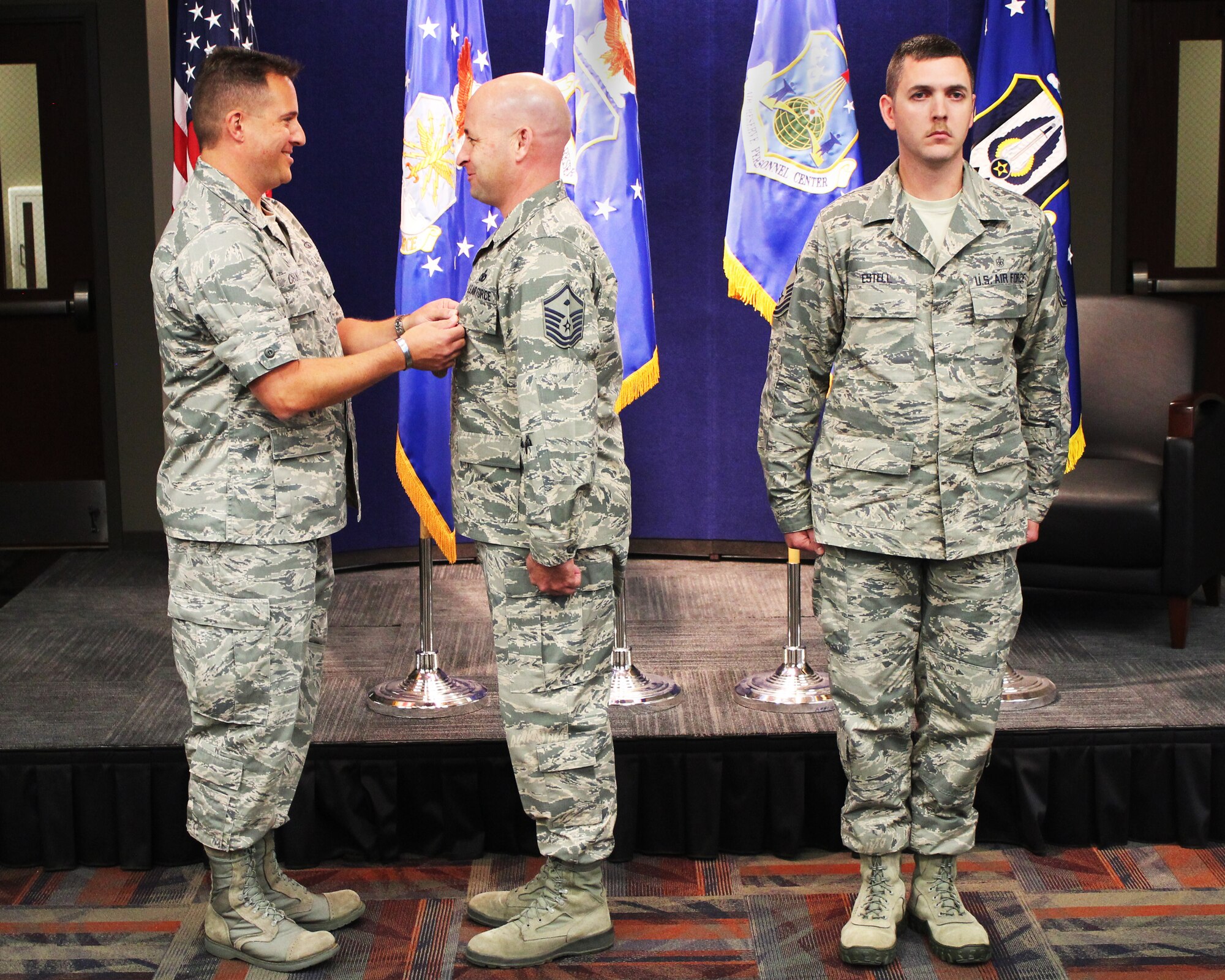 Col. Chistopher Cronce, Headquarters Individual Reservist Readiness and Integration Organization commander, presents Master Sgt. Jerrod Kester, HQ RIO first sergeant, with a Meritorious Service Medal during the first HQ RIO commander's call at the Air Reserve Personnel Center. (Photo by Master Sgt. Timm Huffman)