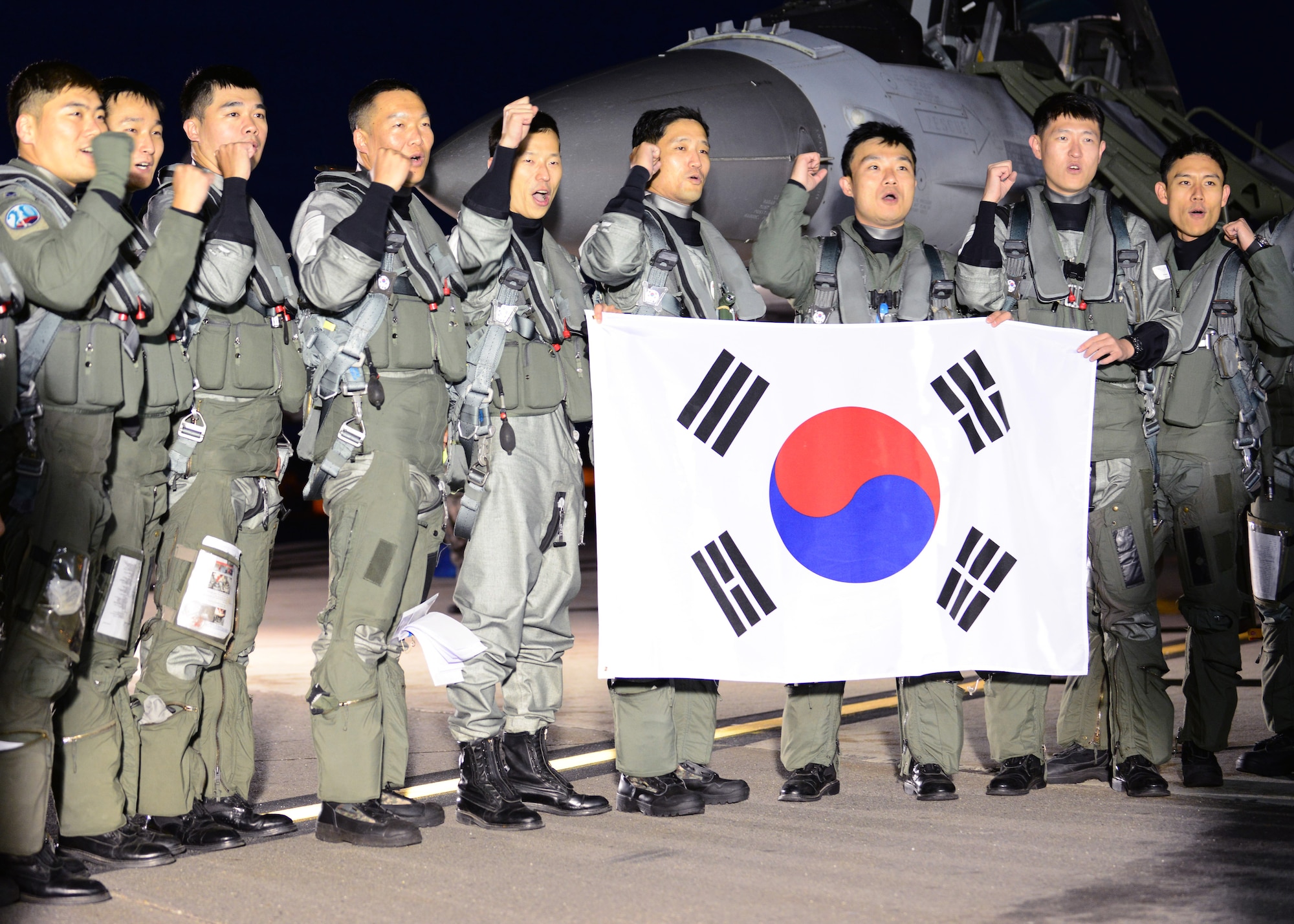 Republic of Korea air force pilots from the 20th Fighter Wing and 38th Fighter Group cheer after their first successful F-16 Fighting Falcon fighter aircraft crossing of the Pacific Ocean Sept. 24, 2014, Eielson Air Force Base, Alaska. Service members from the U.S. Air Force, U.S. Army, U.S. Navy, U.S. Marine Corps and the Republic of Korea participated in RED FLAG-Alaska 15-1, a two-week tactical air combat exercise designed to replicate the stress warfighters face during their first 10 combat sorties of a conflict. (U.S. Air Force photo by Senior Airman Ashley Nicole Taylor/Released)
